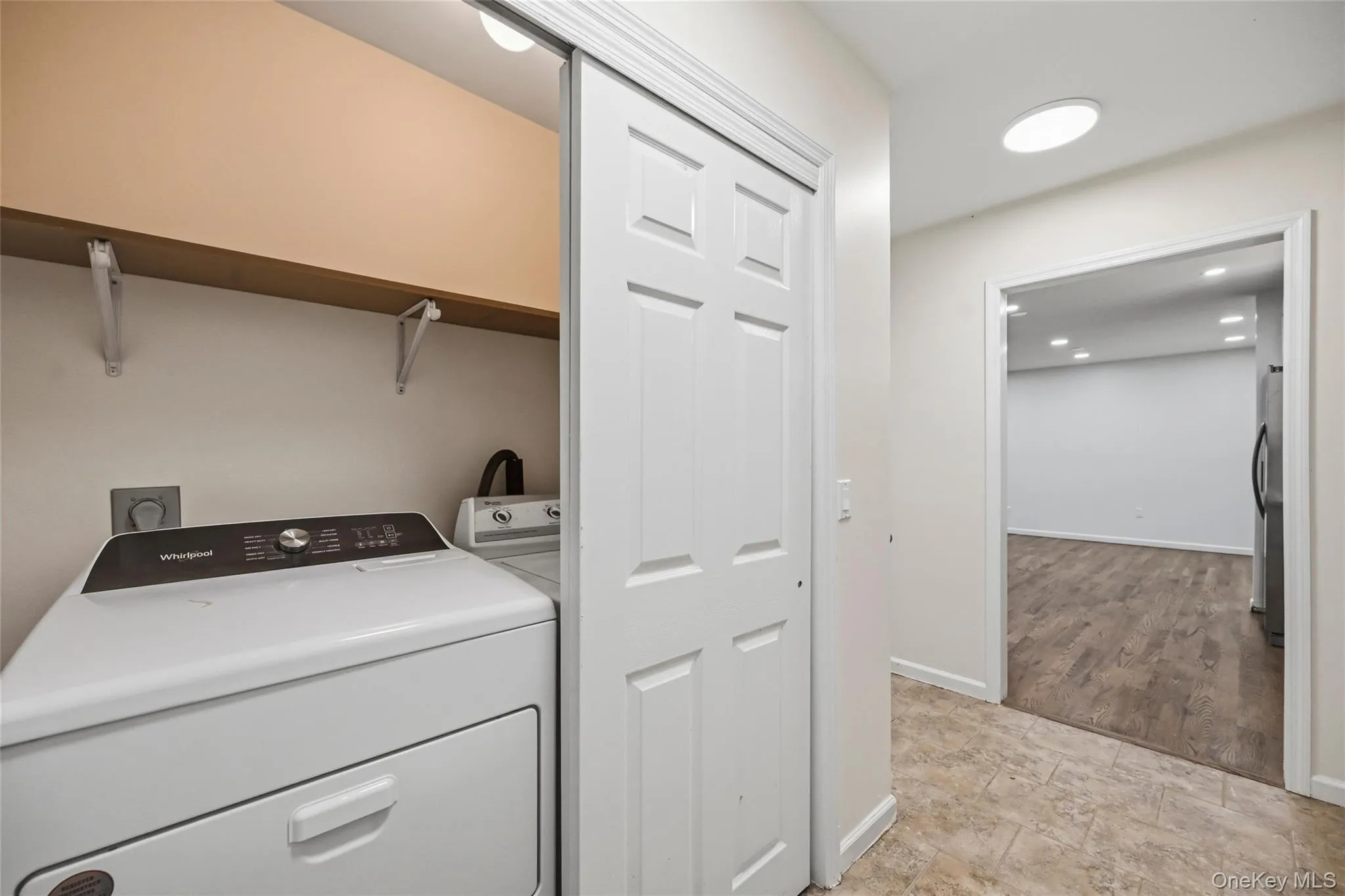 Laundry area with a built-in shelf and sliding panel doors Laundry area with a built-in shelf and sliding panel doors