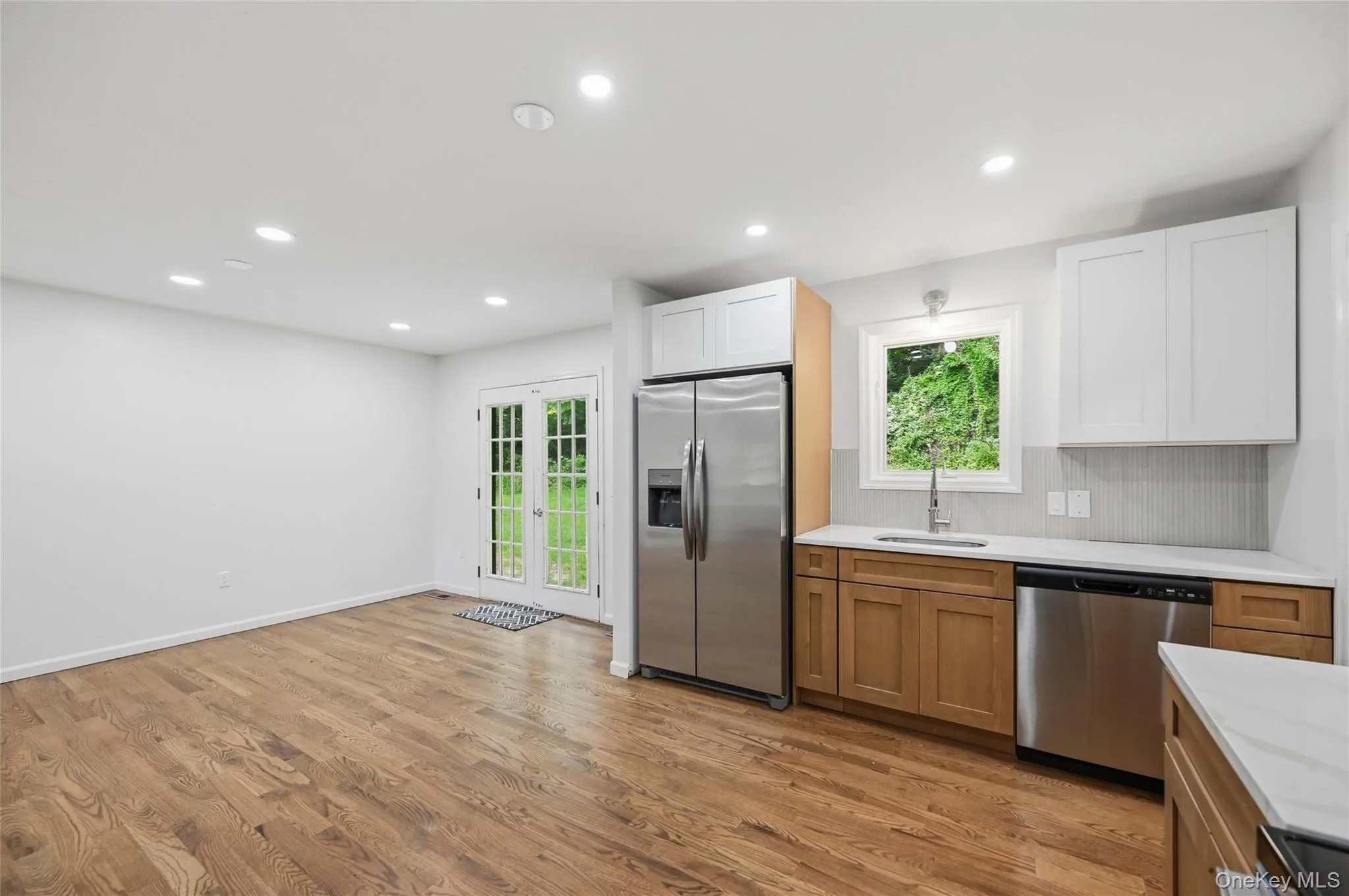Recessed lighting, wood-finish flooring, stainless steel appliances, dual-tone cabinetry, and French doors Recessed lighting, wood-finish flooring, stainless steel appliances, dual-tone cabinetry, and French doors
