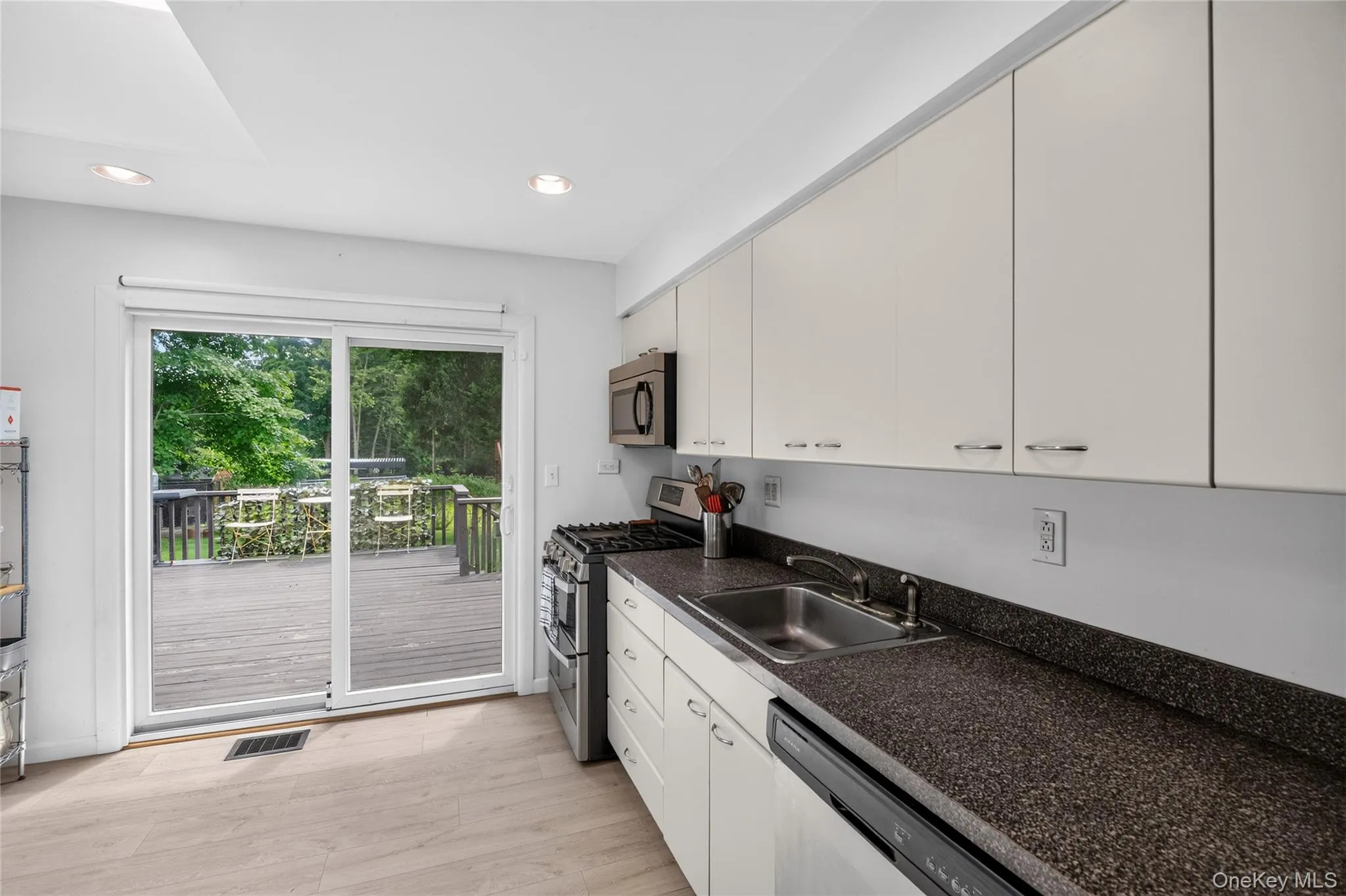 Kitchen with easy access sliders to the large deck Kitchen with easy access sliders to the large deck