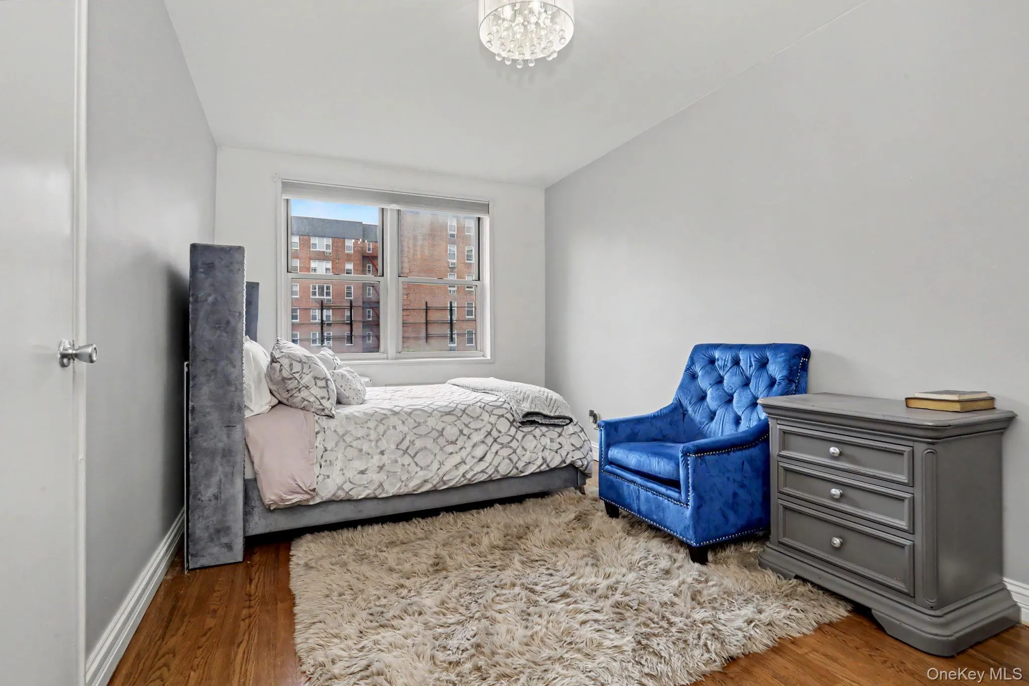 Hardwood-finish flooring, recessed window, and overhead lighting fixture Hardwood-finish flooring, recessed window, and overhead lighting fixture