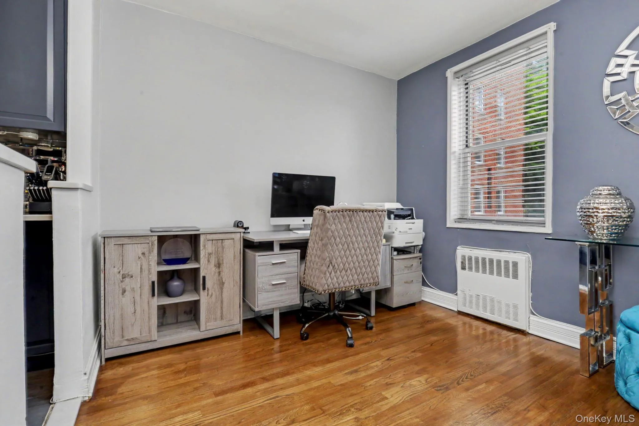 Hardwood flooring, painted walls, and a window with blinds Hardwood flooring, painted walls, and a window with blinds