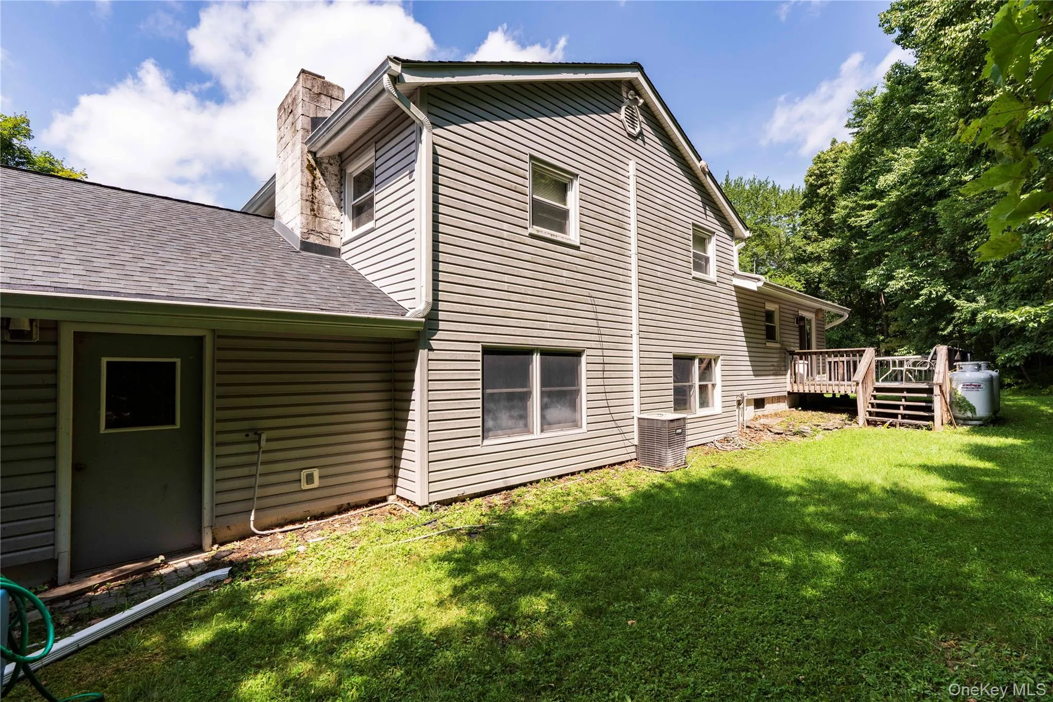 Exterior vinyl siding, multiple windows, a wrap-around outdoor deck Exterior vinyl siding, multiple windows, a wrap-around outdoor deck