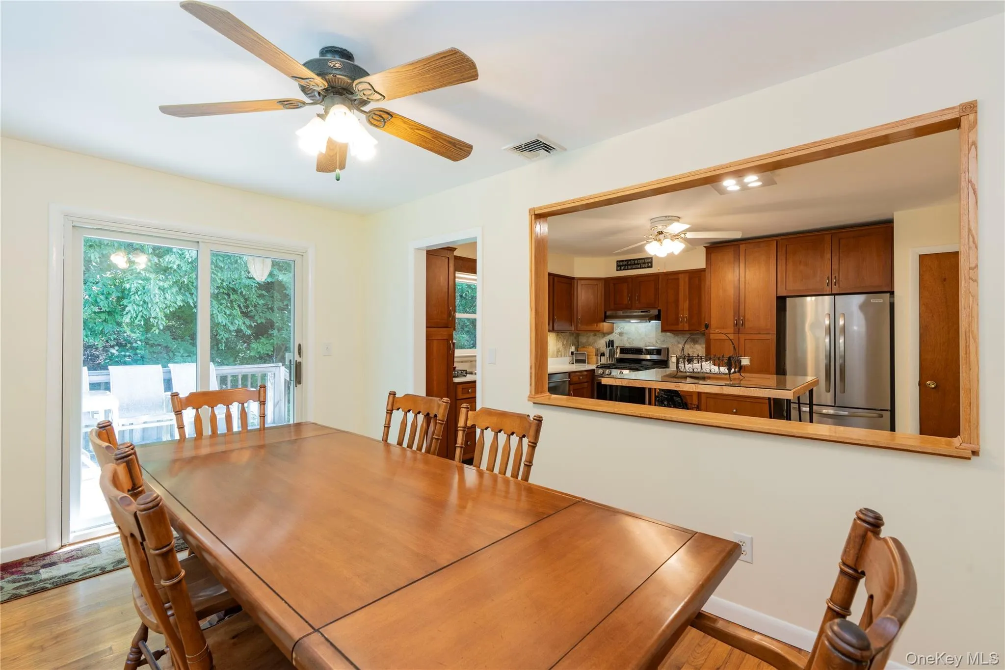 Formal Dining Room with a slider to the deck and a view of the kitchen Formal Dining Room with a slider to the deck and a view of the kitchen
