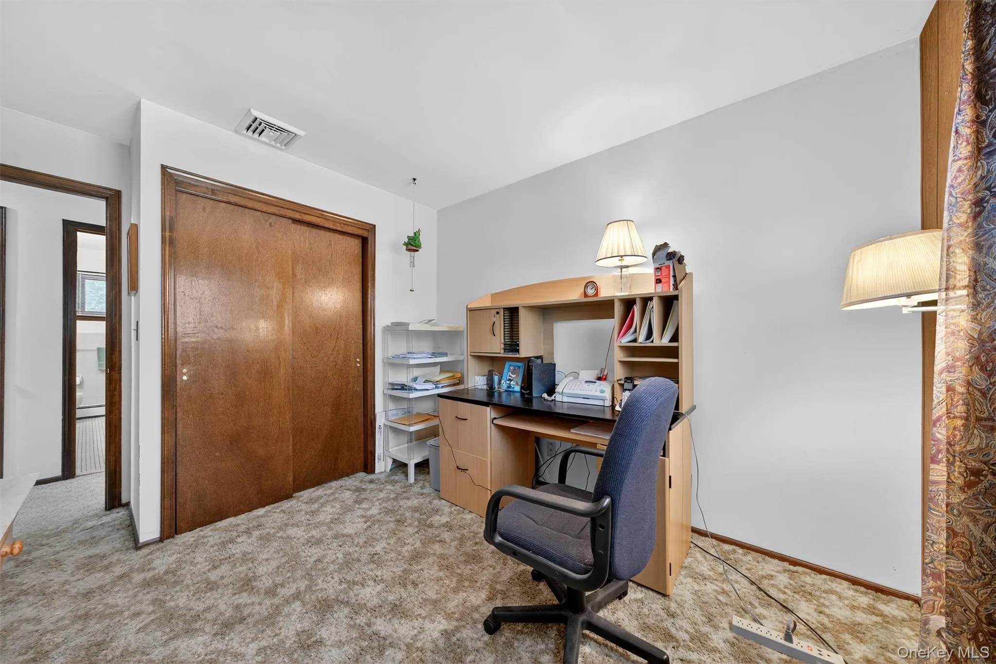 Carpeted office with baseboards Carpeted office with baseboards