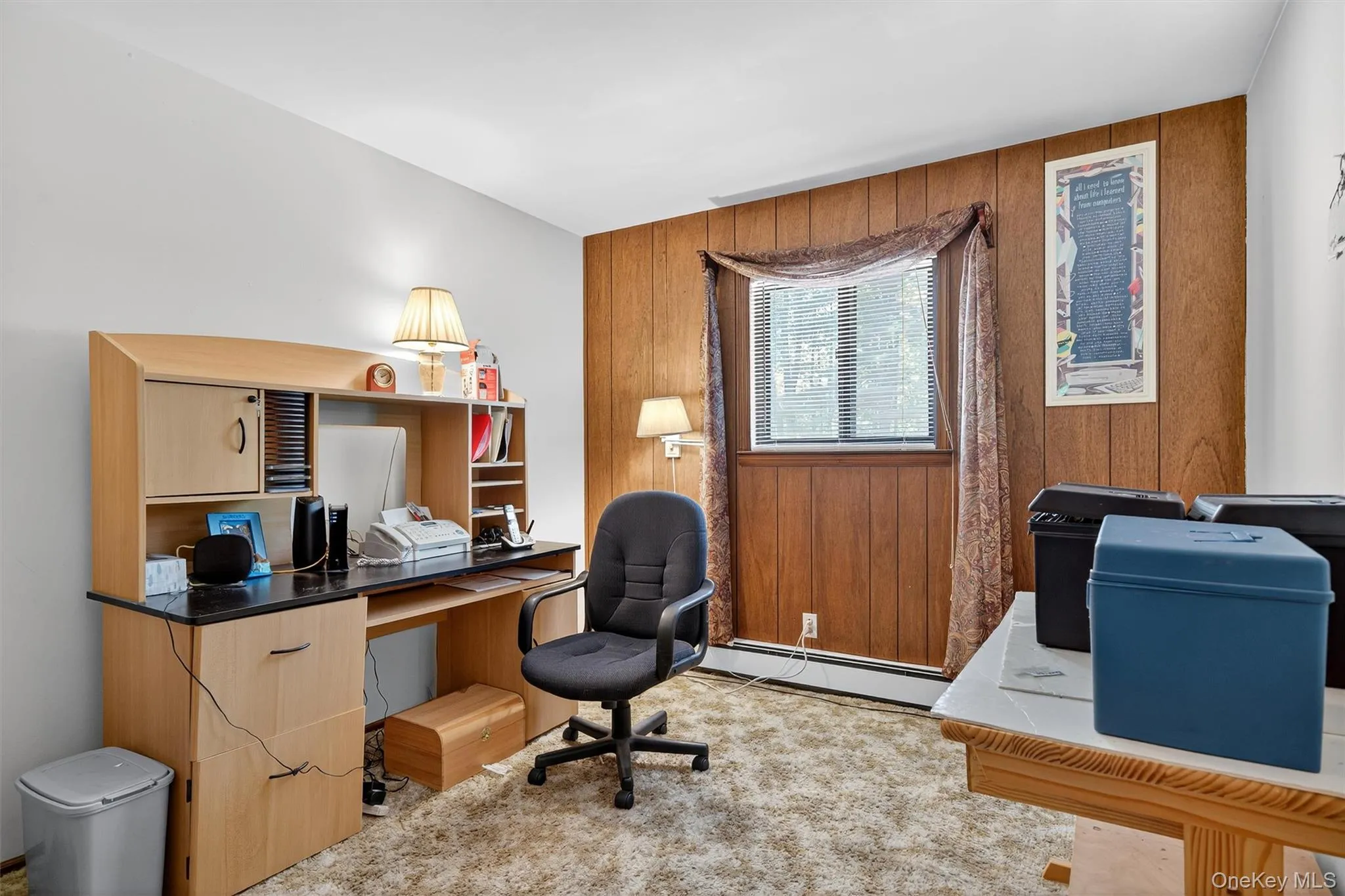 Home office featuring a baseboard radiator and wood walls Home office featuring a baseboard radiator and wood walls
