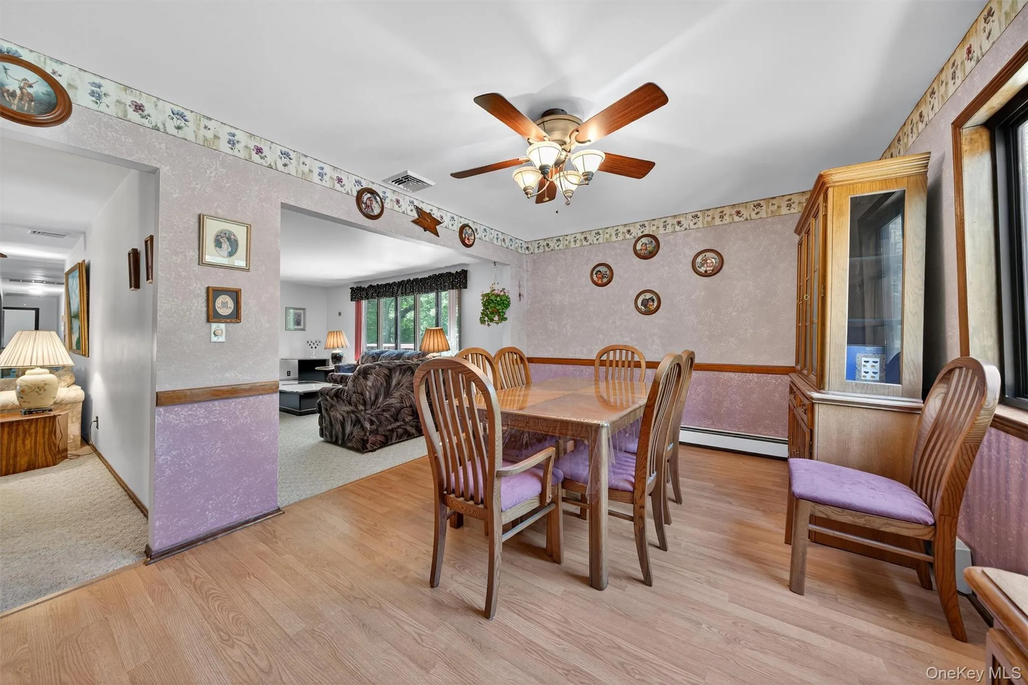 Dining room featuring wallpapered walls, a baseboard radiator, light wood-type flooring, and ceiling fan Dining room featuring wallpapered walls, a baseboard radiator, light wood-type flooring, and ceiling fan