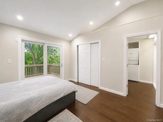 Vaulted ceiling with recessed lighting, wood-finish flooring, sliding glass door to exterior decking, and bi-fold closet doors Vaulted ceiling with recessed lighting, wood-finish flooring, sliding glass door to exterior decking, and bi-fold closet doors