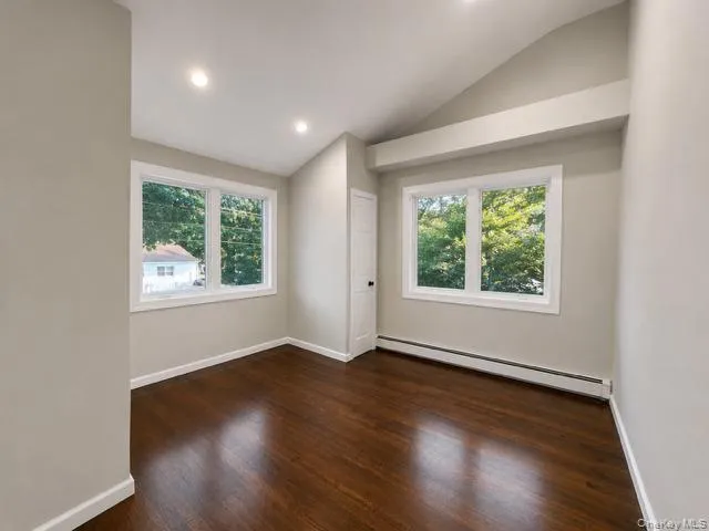 Bright, open room flooded with natural light through dual casement windows Bright, open room flooded with natural light through dual casement windows