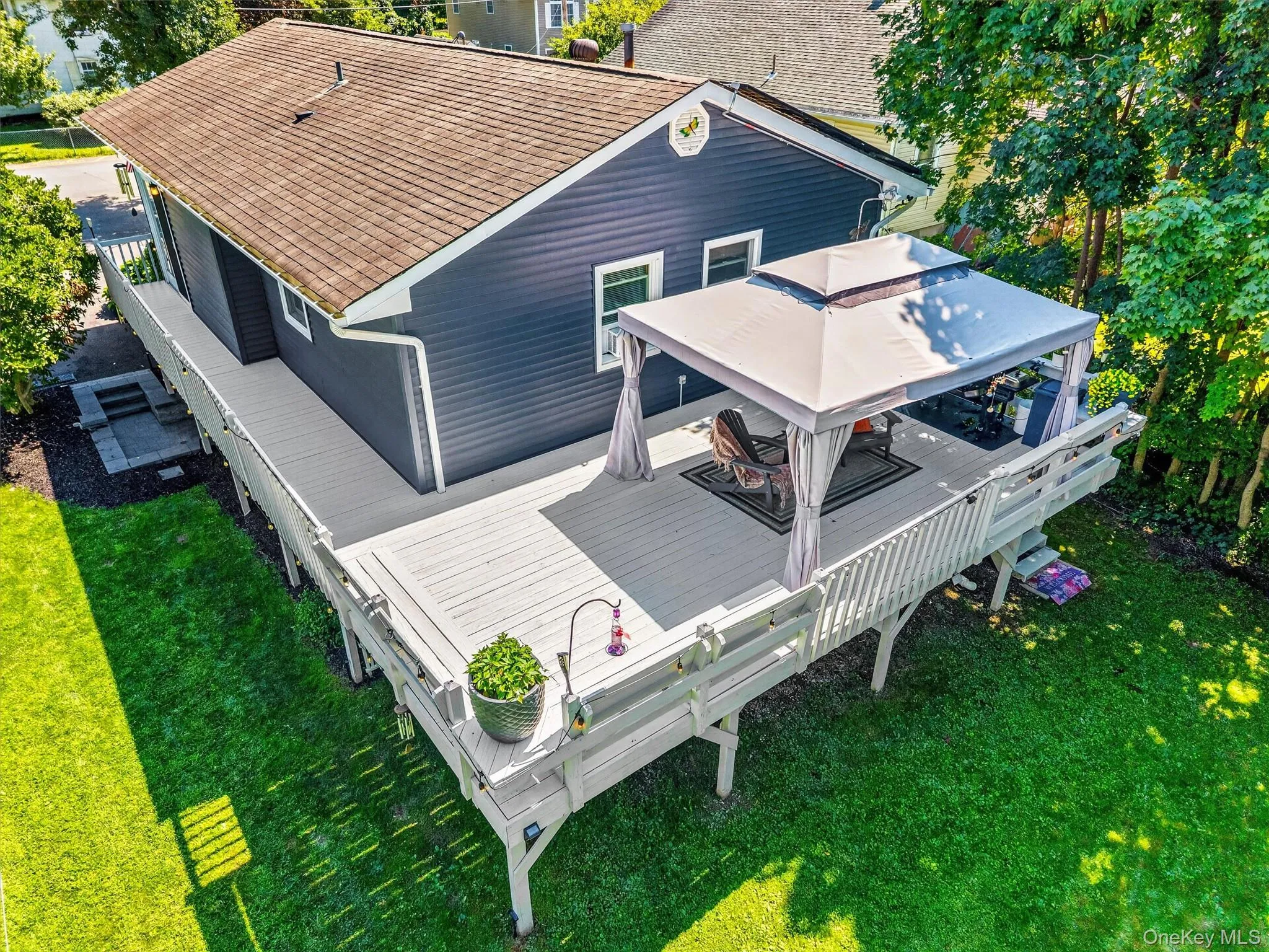 Highlighting the back of the home with expansive wrap around deck Highlighting the back of the home with expansive wrap around deck