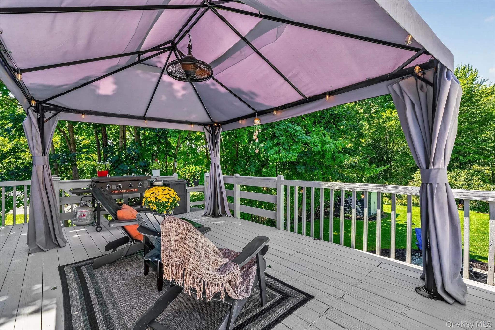 Deck with a gazebo featuring a ceiling fan and string lights Deck with a gazebo featuring a ceiling fan and string lights