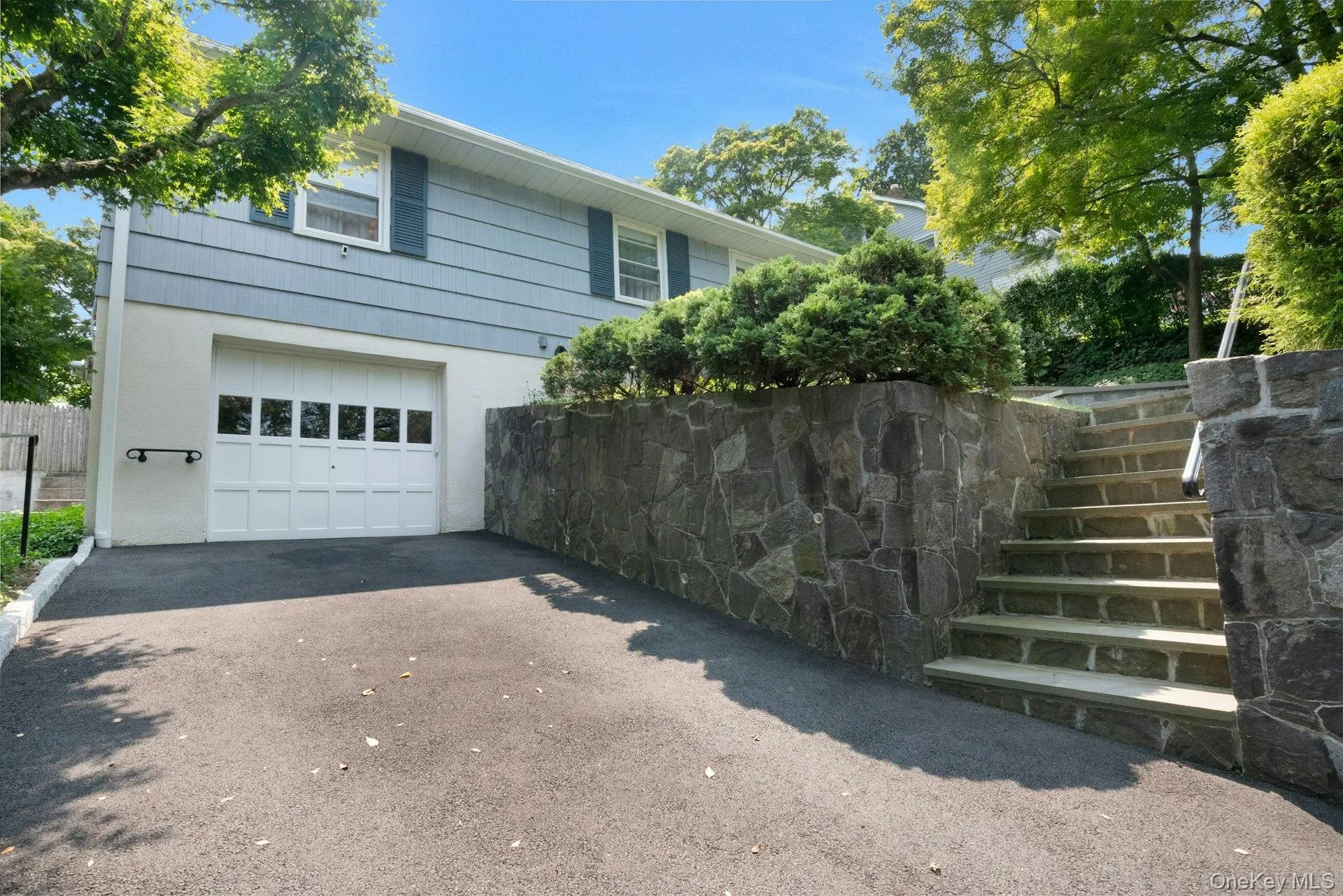 Oversized driveway with one car garage. Oversized driveway with one car garage.