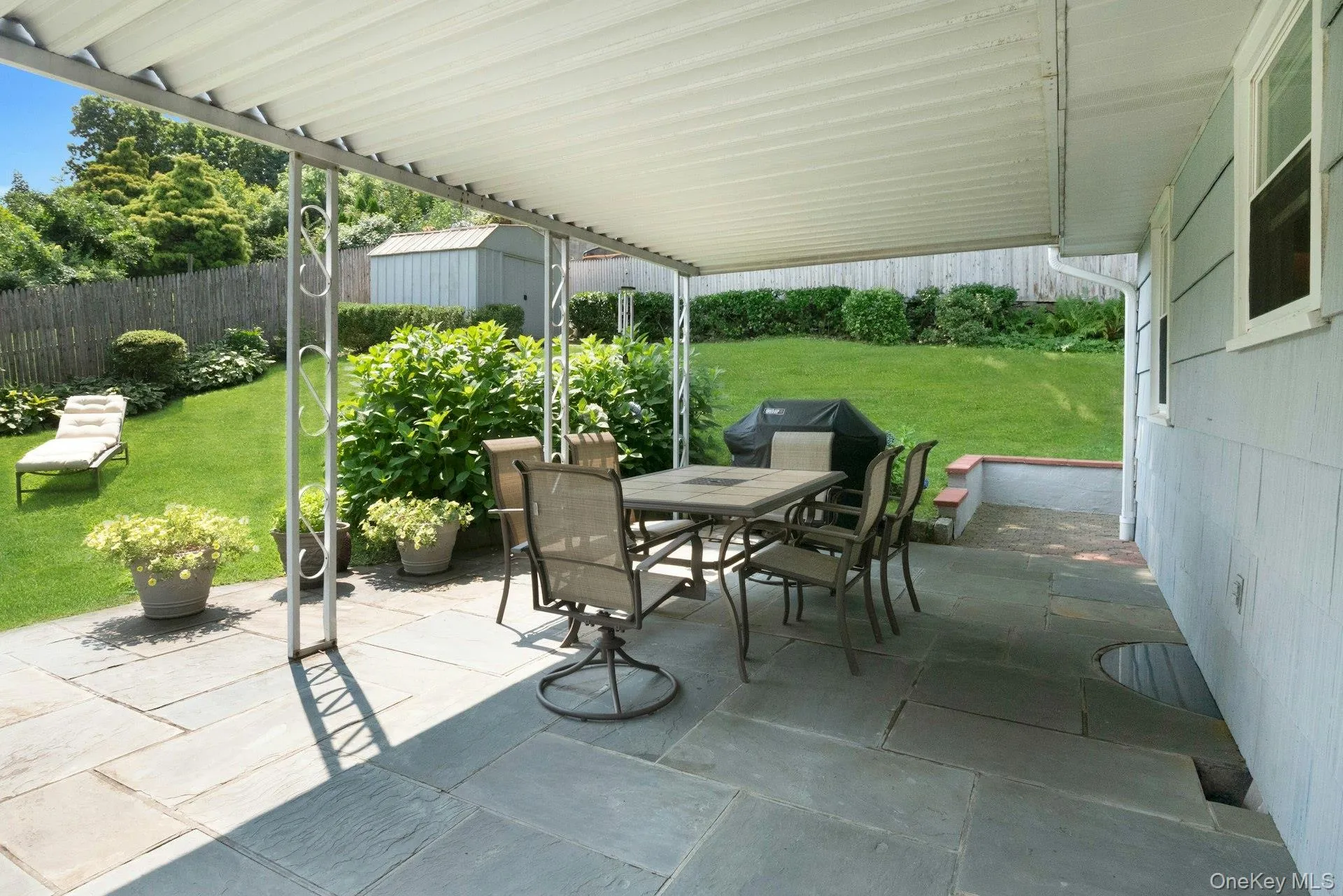 Covered patio area and fenced in yard perfect for entertaining. Covered patio area and fenced in yard perfect for entertaining.