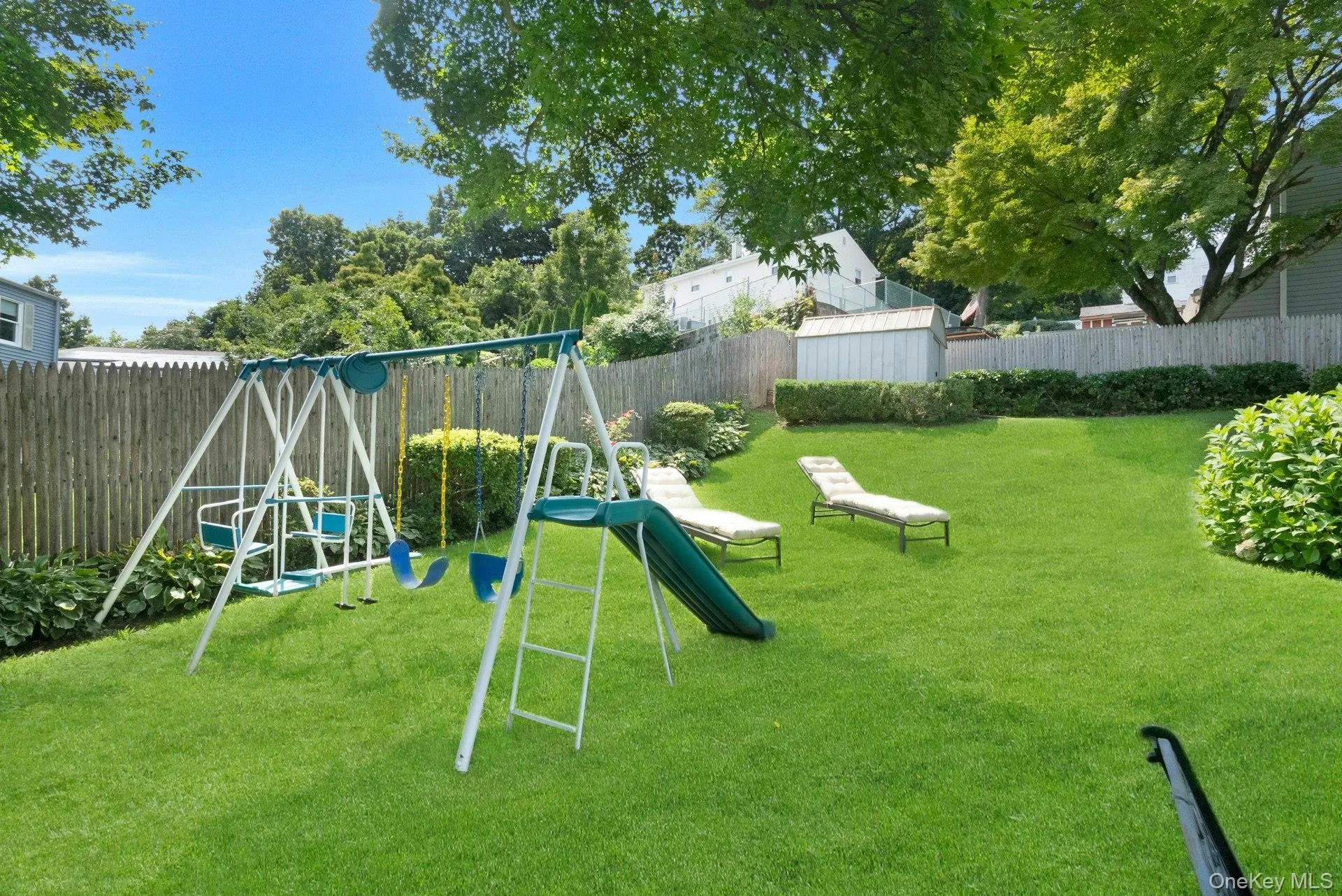 Another of yard with swing set. Another of yard with swing set.