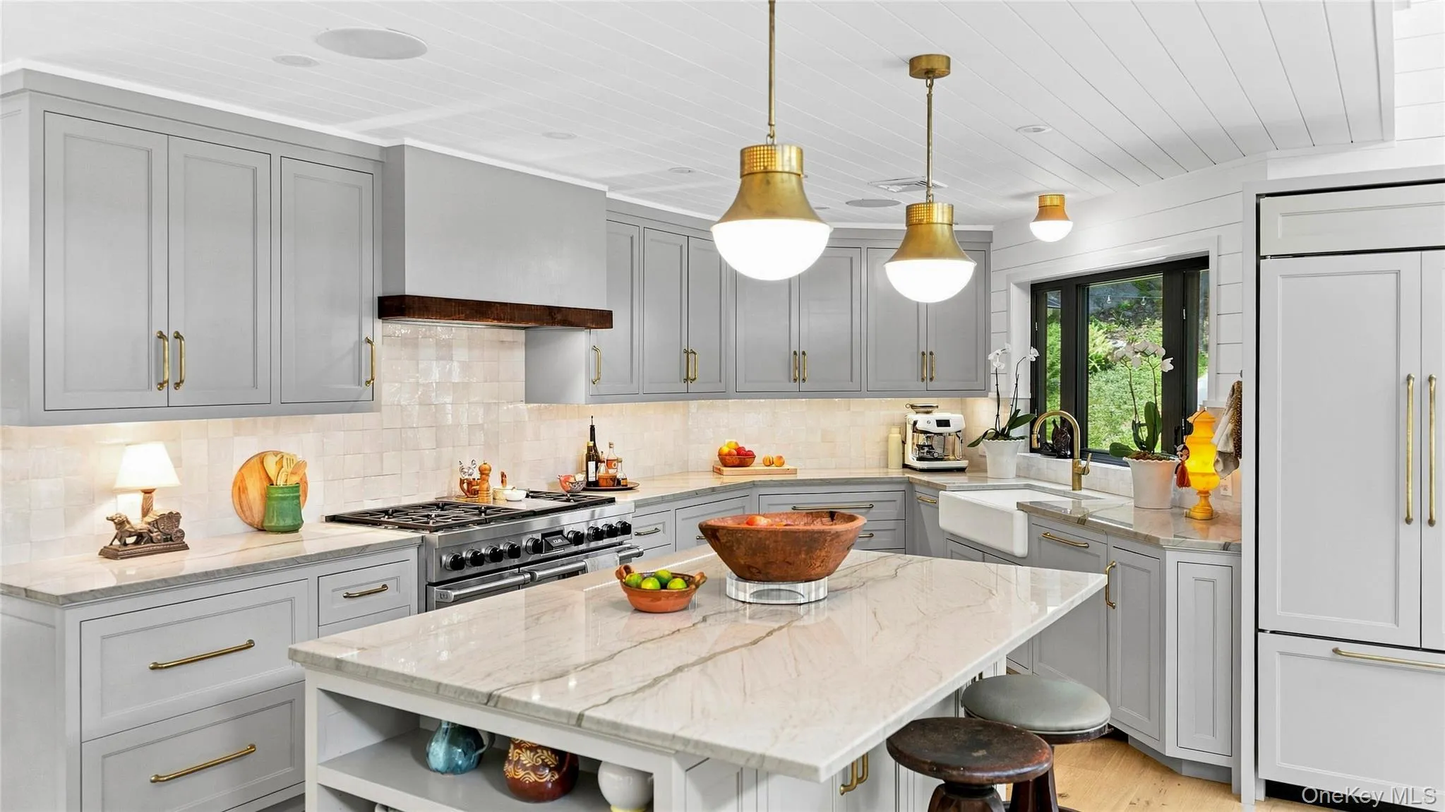 Designer kitchen with Taj Mahal quartzite, custom cabinetry and a professional-grade Wolf, Sub-Zero and Cove appliance suite. Designer kitchen with Taj Mahal quartzite, custom cabinetry and a professional-grade Wolf, Sub-Zero and Cove appliance suite.