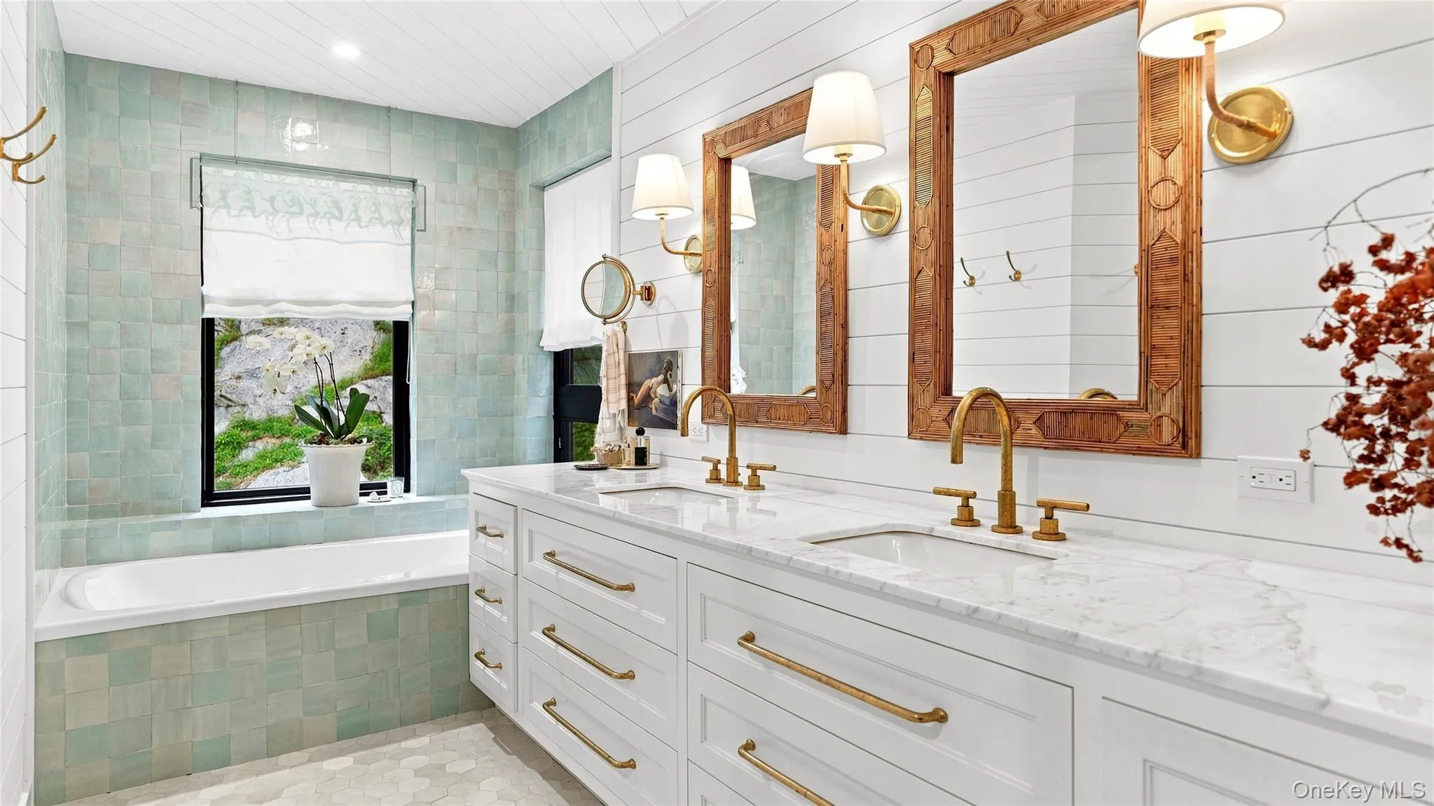 Spa-like primary bath with custom double vanity, soaking tub, radiant-heated floors and tranquil wooded views. Spa-like primary bath with custom double vanity, soaking tub, radiant-heated floors and tranquil wooded views.