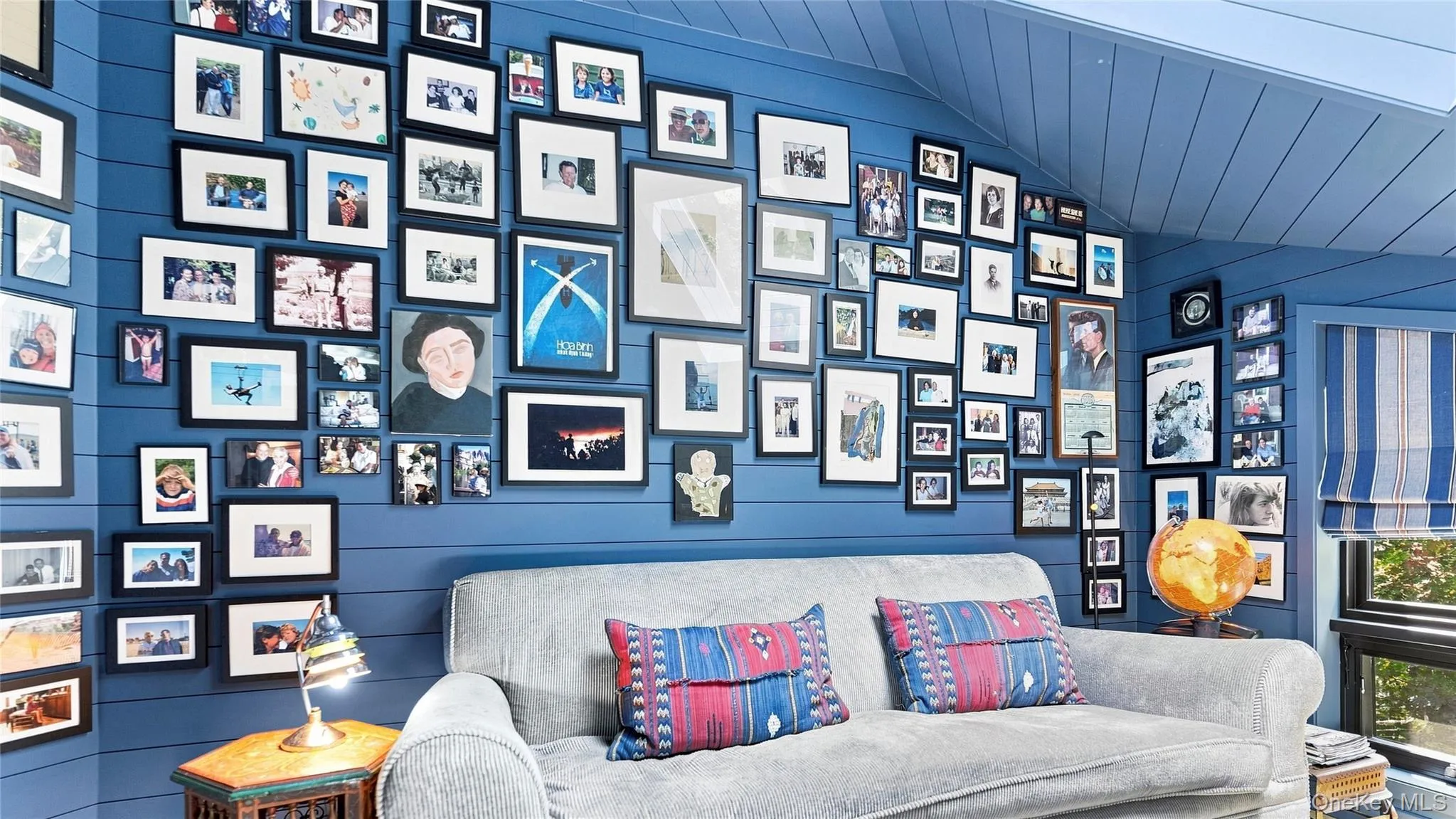 A playful gallery wall gives the intimate den its own distinctive personality A playful gallery wall gives the intimate den its own distinctive personality