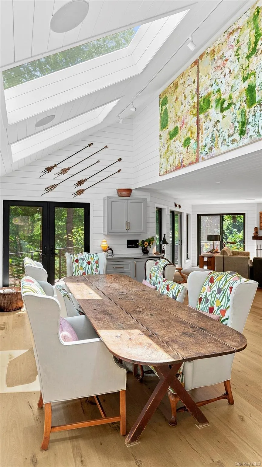 Dining area surrounded by windows and woodland views—a relaxed setting equally suited to intimate dinners and a full house of guests. Dining area surrounded by windows and woodland views—a relaxed setting equally suited to intimate dinners and a full house of guests.