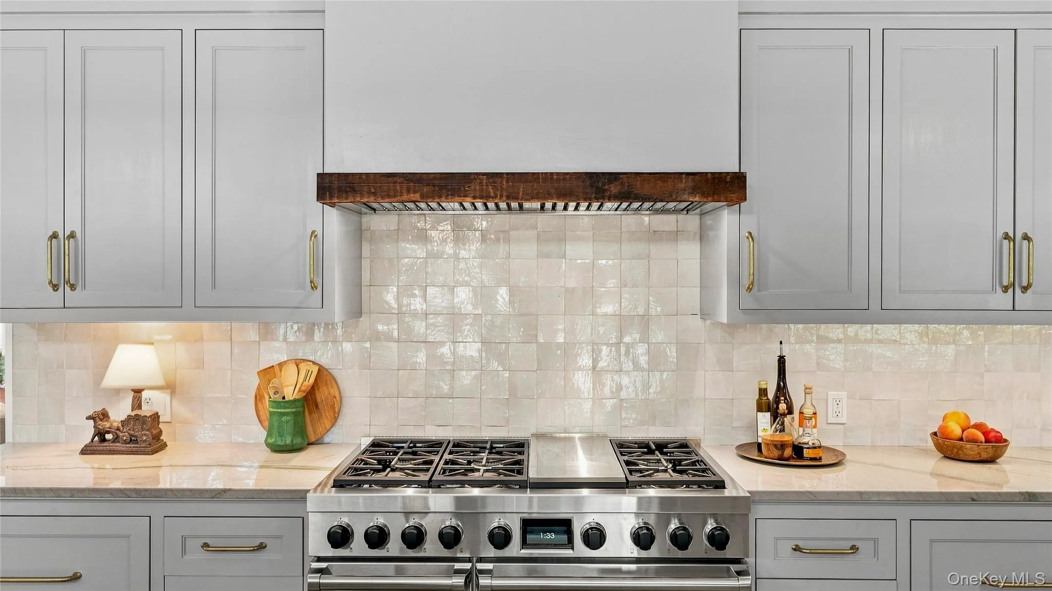 Professional-grade Wolf range with six burners, griddle and double ovens—part of a kitchen designed for serious cooking and entertaining. Professional-grade Wolf range with six burners, griddle and double ovens—part of a kitchen designed for serious cooking and entertaining.