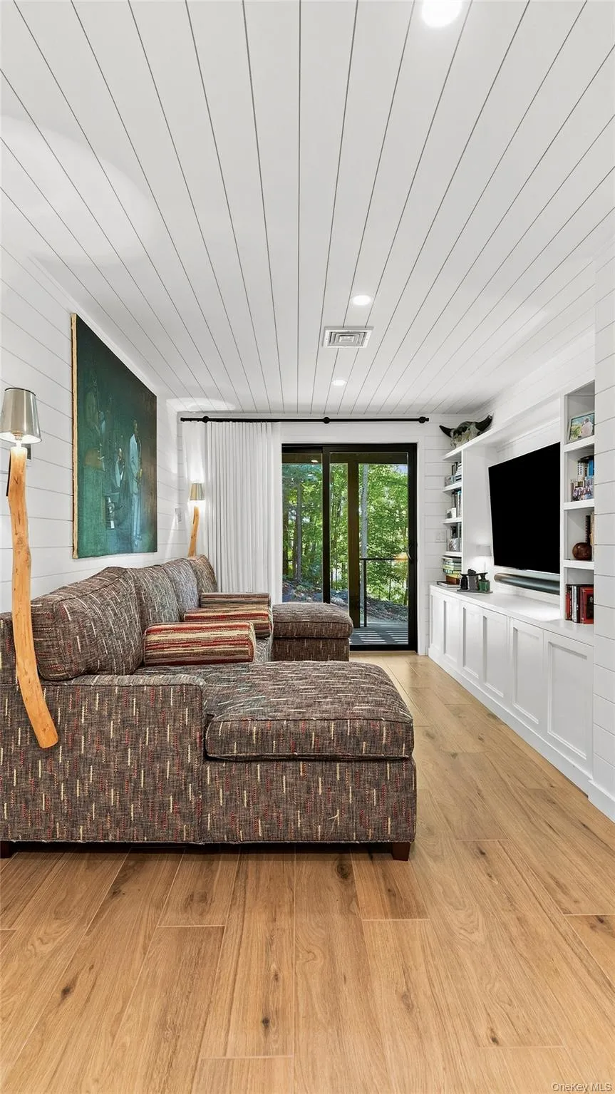 Comfortable lower-level family room with direct outdoor access and flexible space for guests, movies or relaxing. Comfortable lower-level family room with direct outdoor access and flexible space for guests, movies or relaxing.