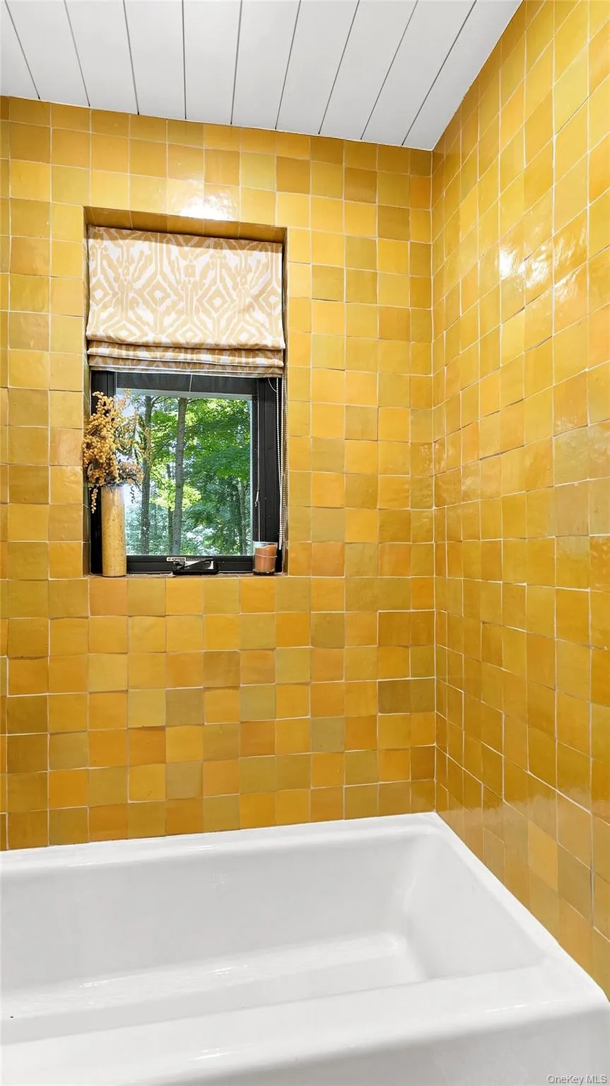 A bold, beautifully tiled bath adds another layer of distinctive design. A bold, beautifully tiled bath adds another layer of distinctive design.