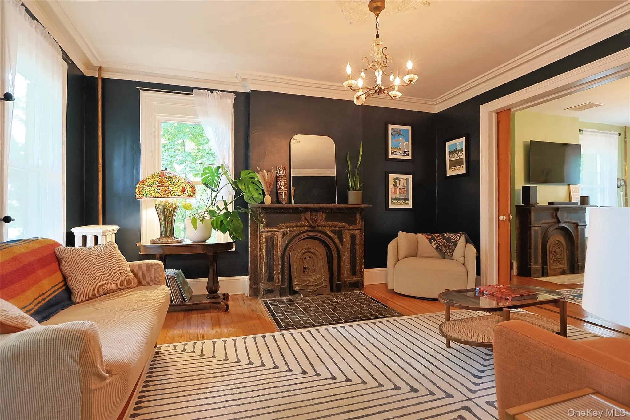 Living room: with plaster crown moldings, pocket doors, stone fireplace mantel Living room: with plaster crown moldings, pocket doors, stone fireplace mantel