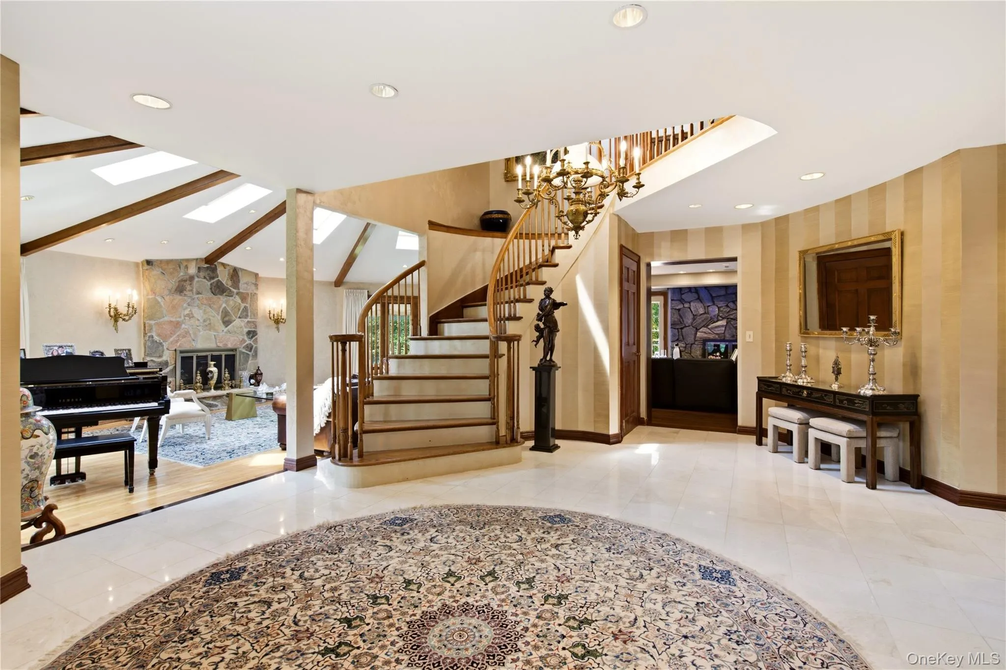 Grand entry with marble flooring, and curved staircase. Grand entry with marble flooring, and curved staircase.