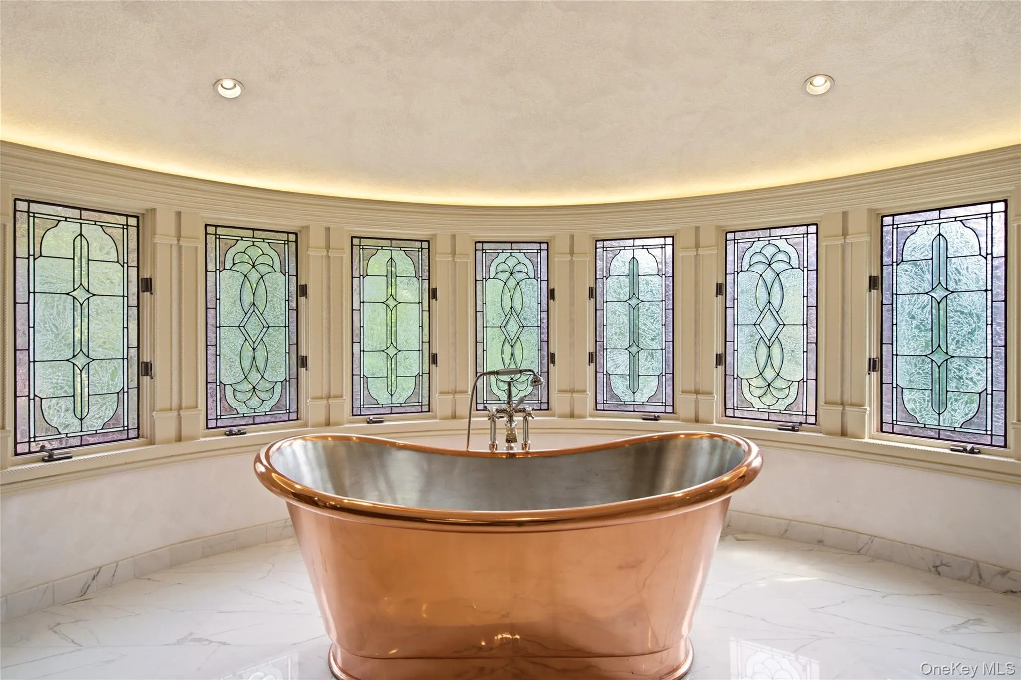 Striking freestanding copper soaking tub, surrounded by stained-glass windows. Striking freestanding copper soaking tub, surrounded by stained-glass windows.
