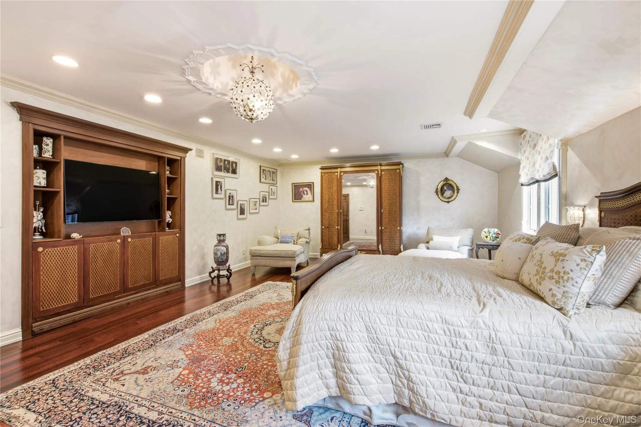 Recessed lighting illuminates wood-finish flooring and a built-in entertainment center Recessed lighting illuminates wood-finish flooring and a built-in entertainment center