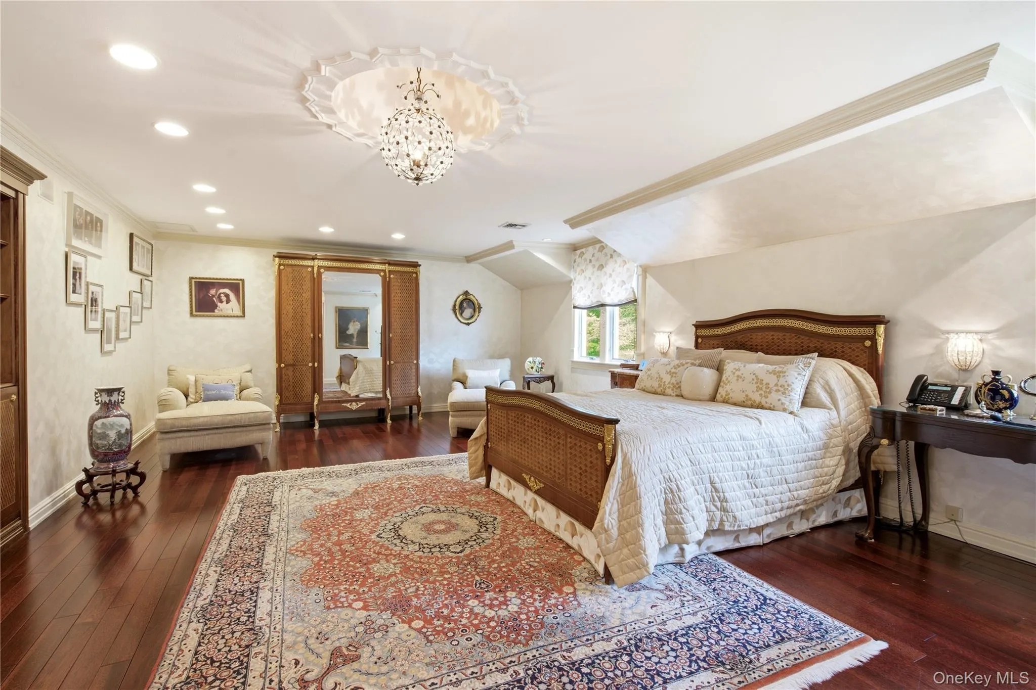 Expansive primary bedroom, featuring two custom outfitted closets, cherrywood flooring. Expansive primary bedroom, featuring two custom outfitted closets, cherrywood flooring.