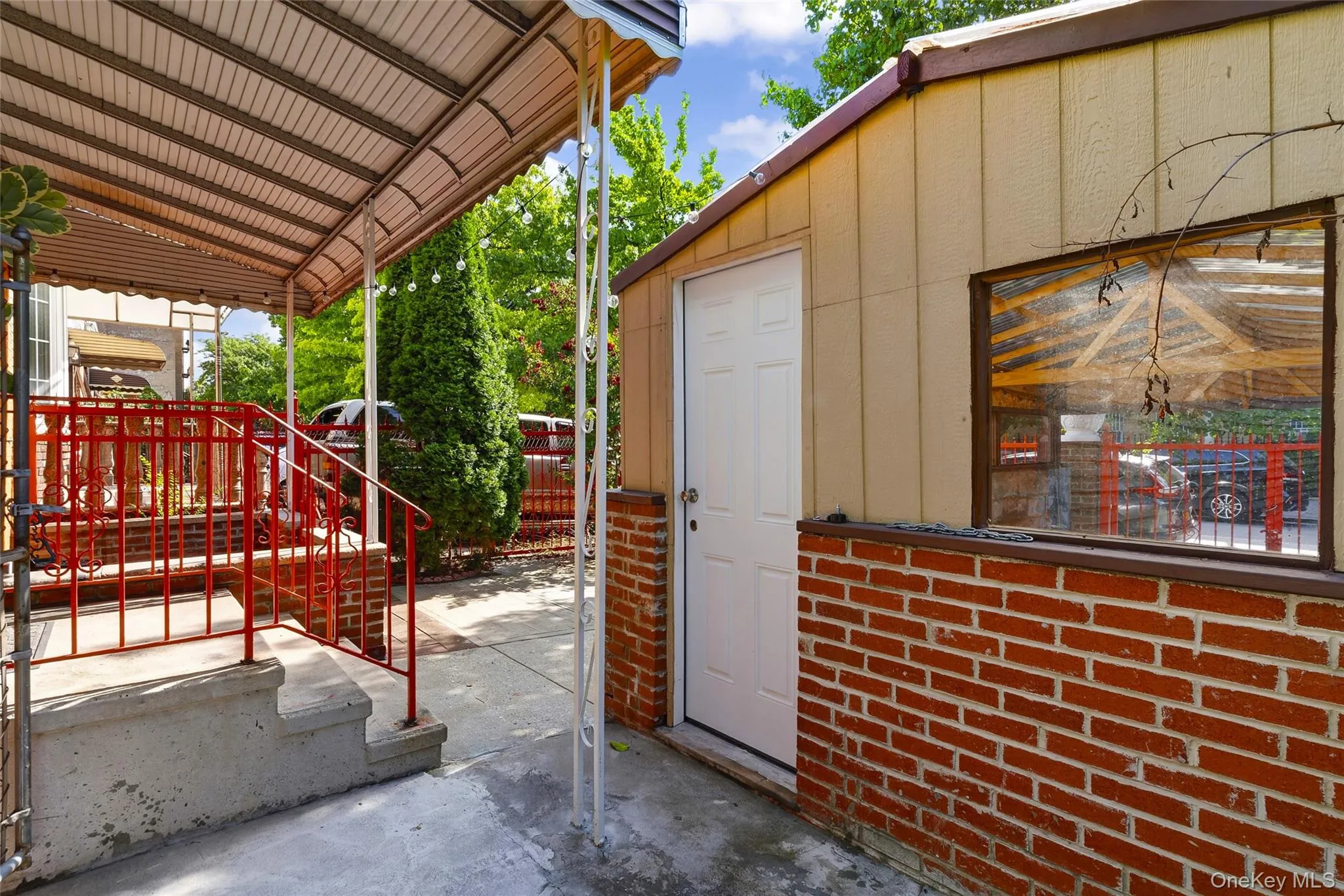 Covered carport with brick accents, private entry door, and covered porch with walkway. Covered carport with brick accents, private entry door, and covered porch with walkway.