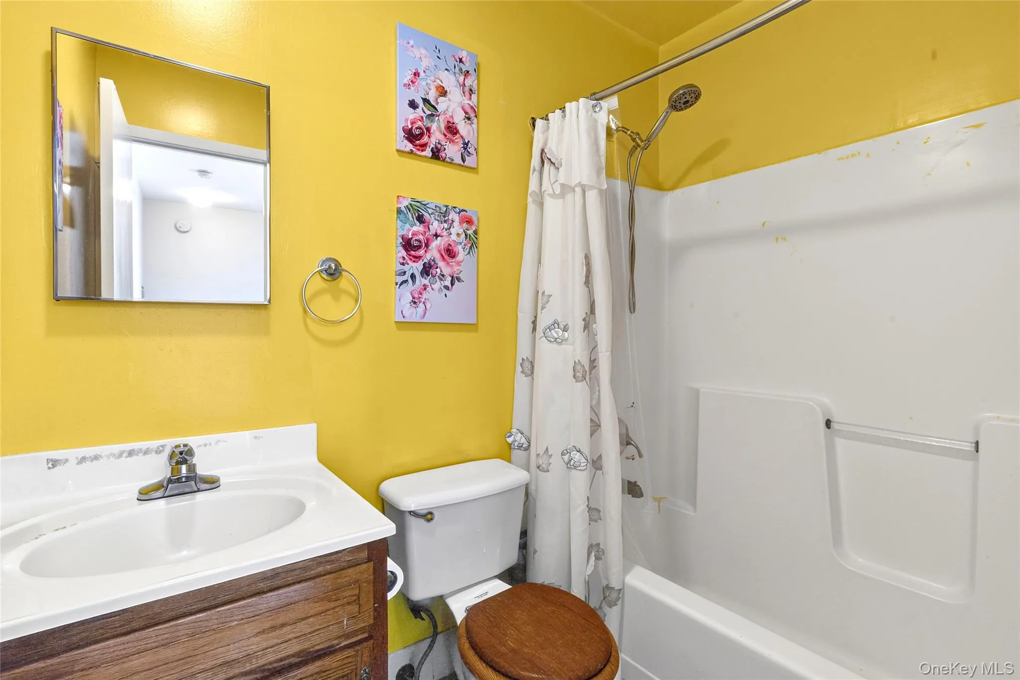 Full bathroom with wall-mounted mirror, and a tub/shower combination Full bathroom with wall-mounted mirror, and a tub/shower combination