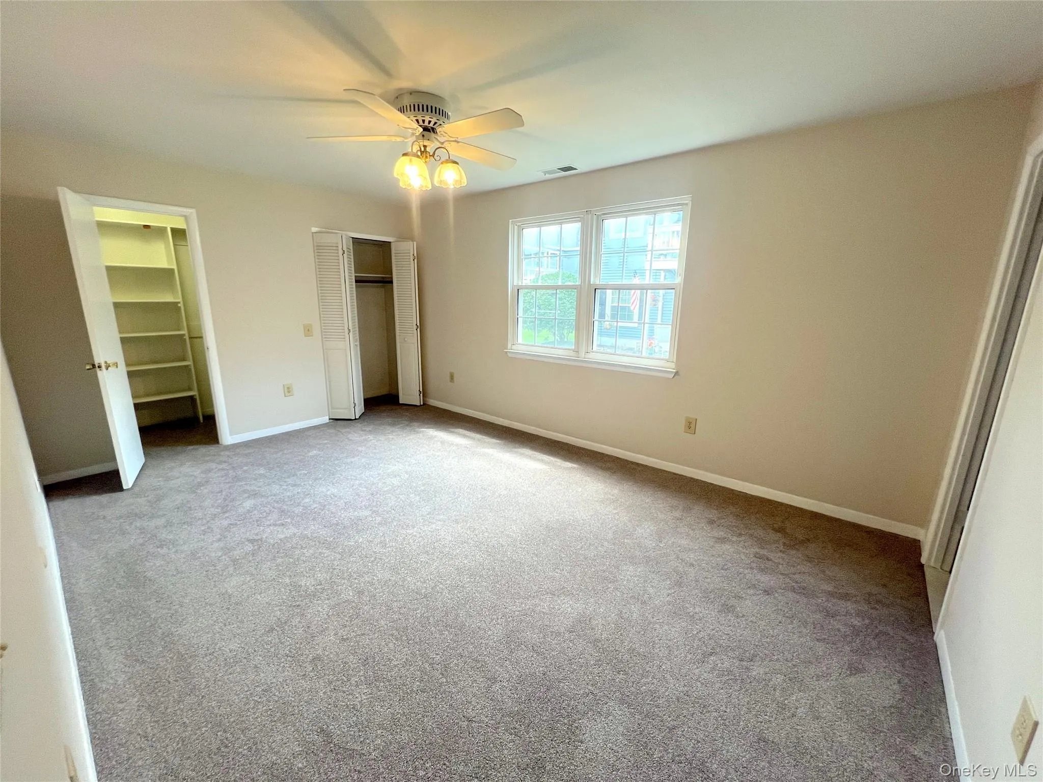 Primary bedroom with two closets including a walk in. Primary bedroom with two closets including a walk in.