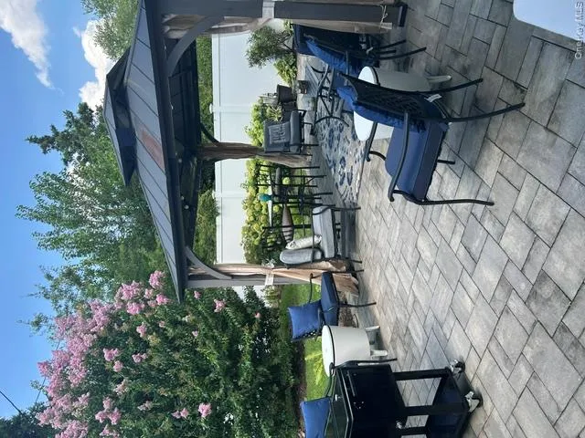 Paver patio with a metal gazebo and privacy curtains Paver patio with a metal gazebo and privacy curtains