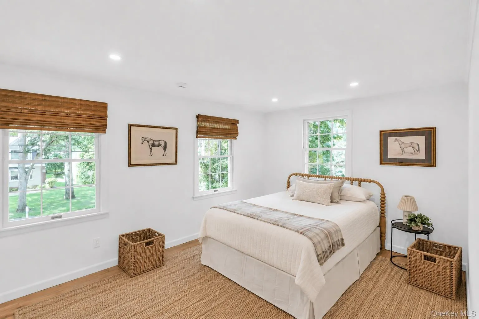Recessed lighting, wood-finish flooring, and multiple double-hung windows with woven wood shades Recessed lighting, wood-finish flooring, and multiple double-hung windows with woven wood shades
