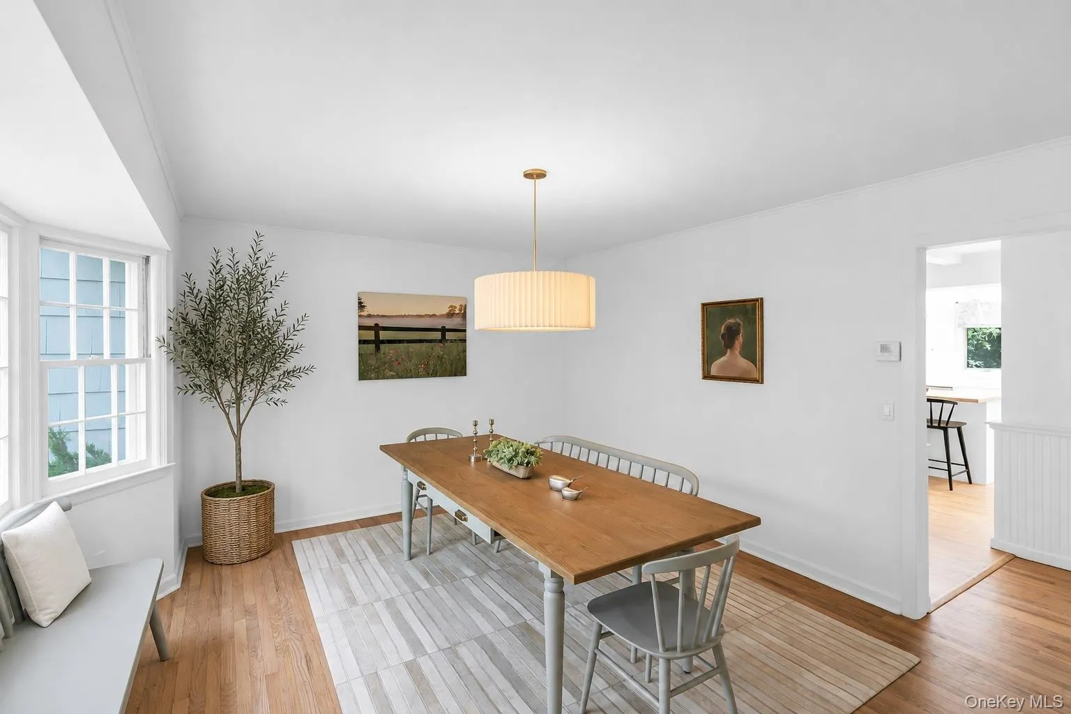 Hardwood flooring, bay window, contemporary chandelier, white walls, and beadboard wainscoting Hardwood flooring, bay window, contemporary chandelier, white walls, and beadboard wainscoting