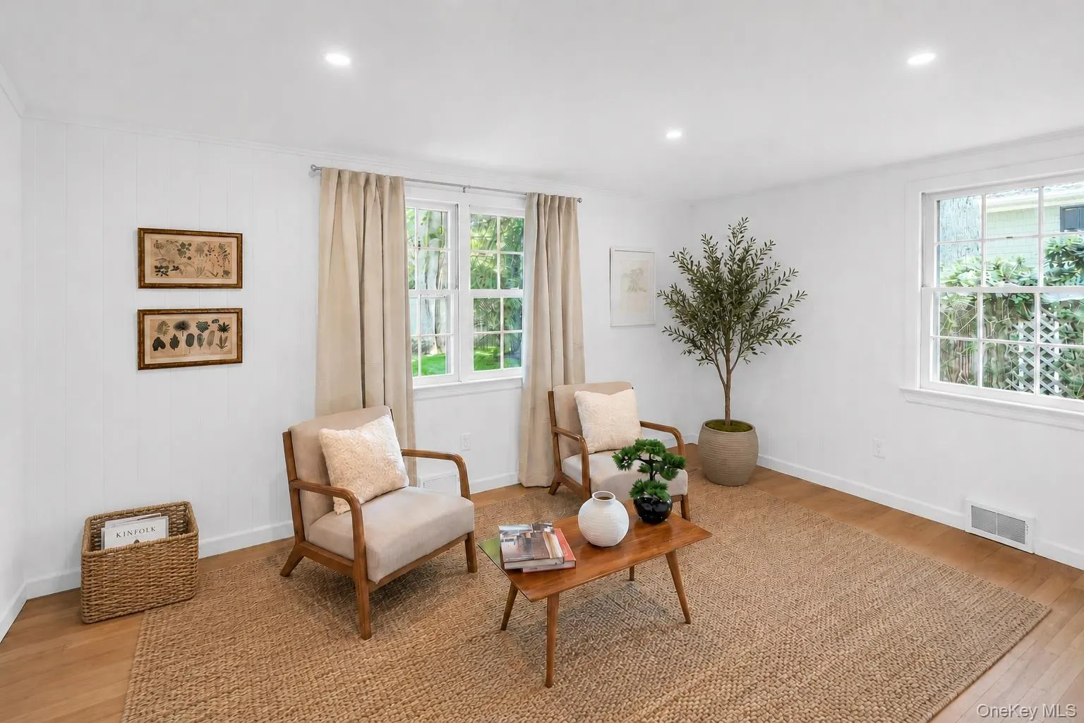 Recessed lighting, light wood-finish flooring, white walls, and multiple windows with white trim Recessed lighting, light wood-finish flooring, white walls, and multiple windows with white trim