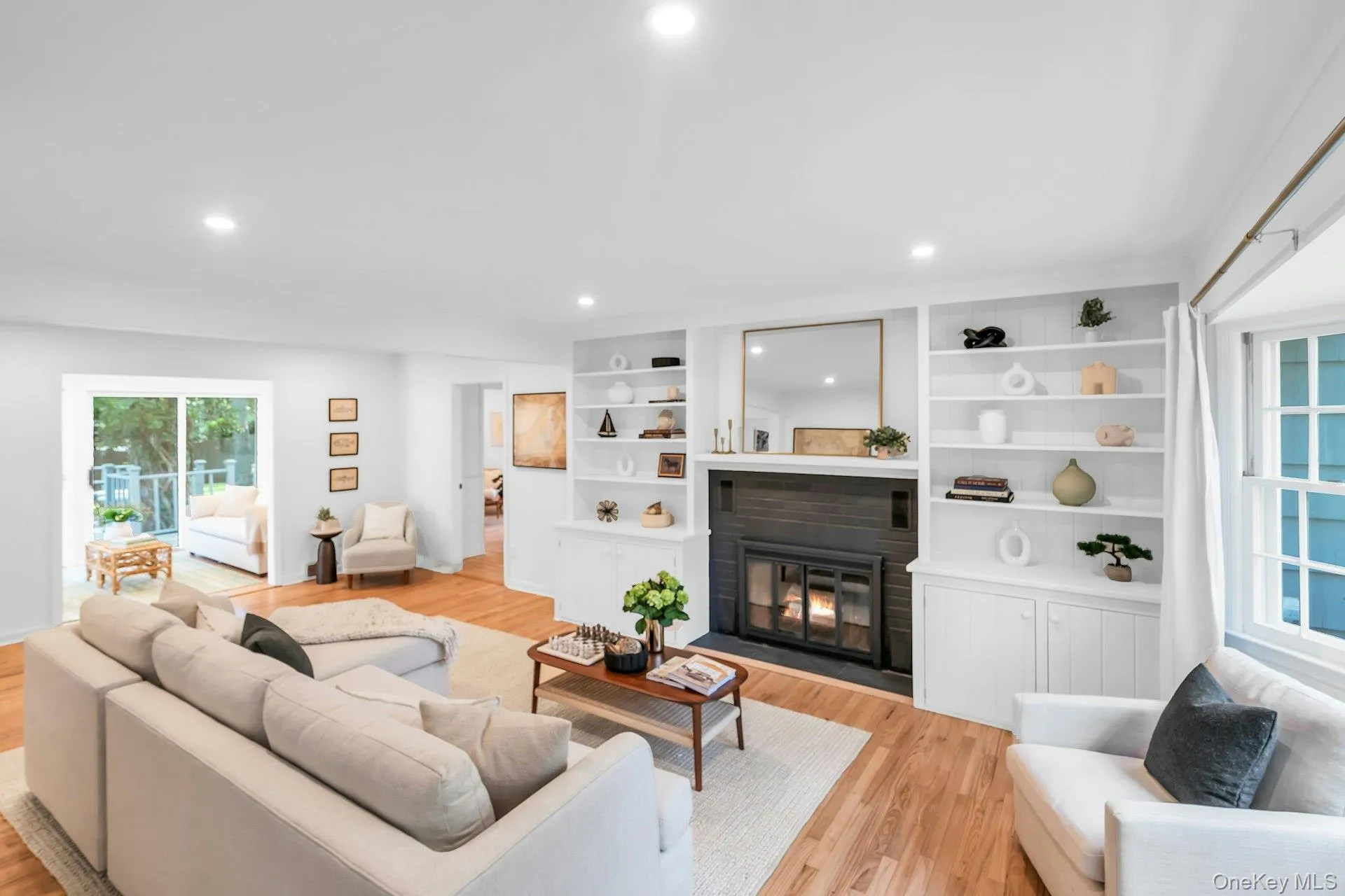 Recessed lighting illuminates wood-finish flooring, a built-in fireplace, and custom shelving Recessed lighting illuminates wood-finish flooring, a built-in fireplace, and custom shelving