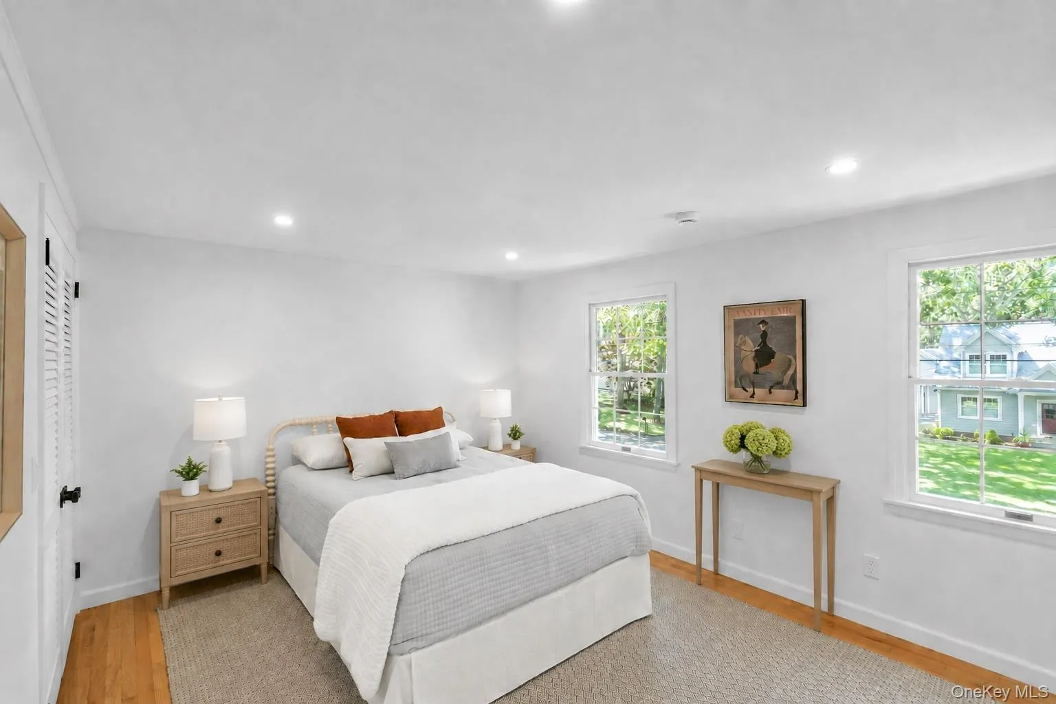 Recessed lighting, wood-finish flooring, and white walls Recessed lighting, wood-finish flooring, and white walls