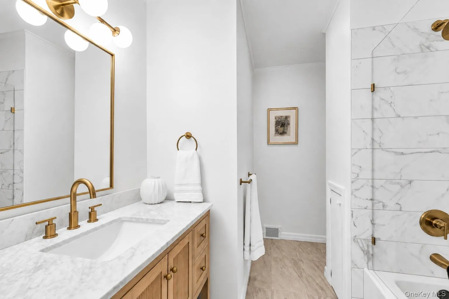 Modern vanity featuring an integrated rectangular sink and gold-tone fixtures Modern vanity featuring an integrated rectangular sink and gold-tone fixtures