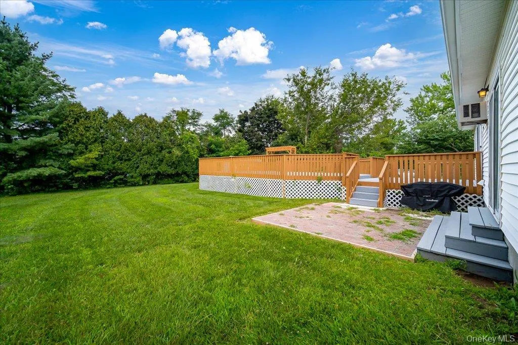 Backyard brick patio adjacent to deck Backyard brick patio adjacent to deck