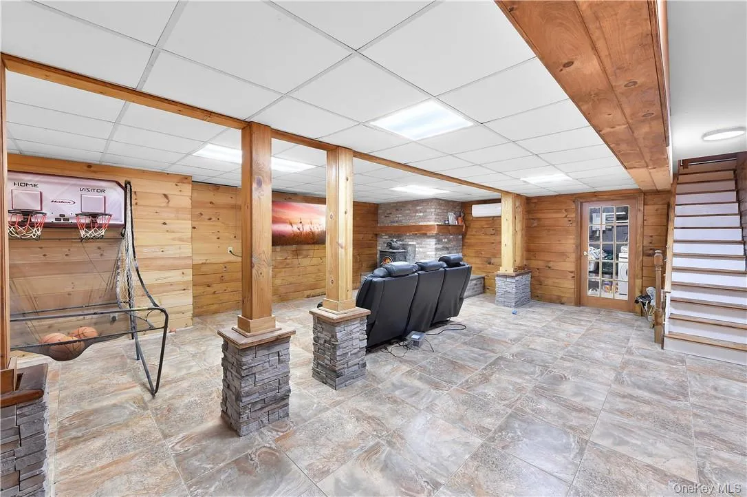 Basement with wooden walls and a paneled ceiling Basement with wooden walls and a paneled ceiling