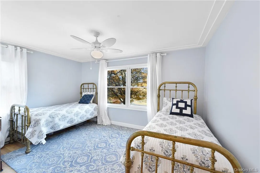 Bedroom with wood-type flooring and ceiling fan Bedroom with wood-type flooring and ceiling fan