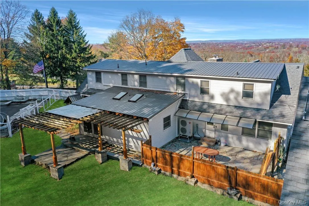 Rear view of property with a patio area, a deck, and a yard Rear view of property with a patio area, a deck, and a yard