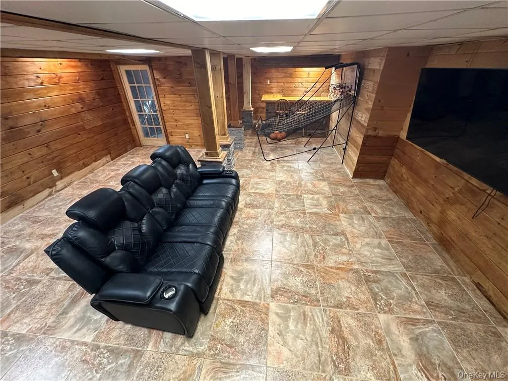 Basement with a drop ceiling and wooden walls Basement with a drop ceiling and wooden walls