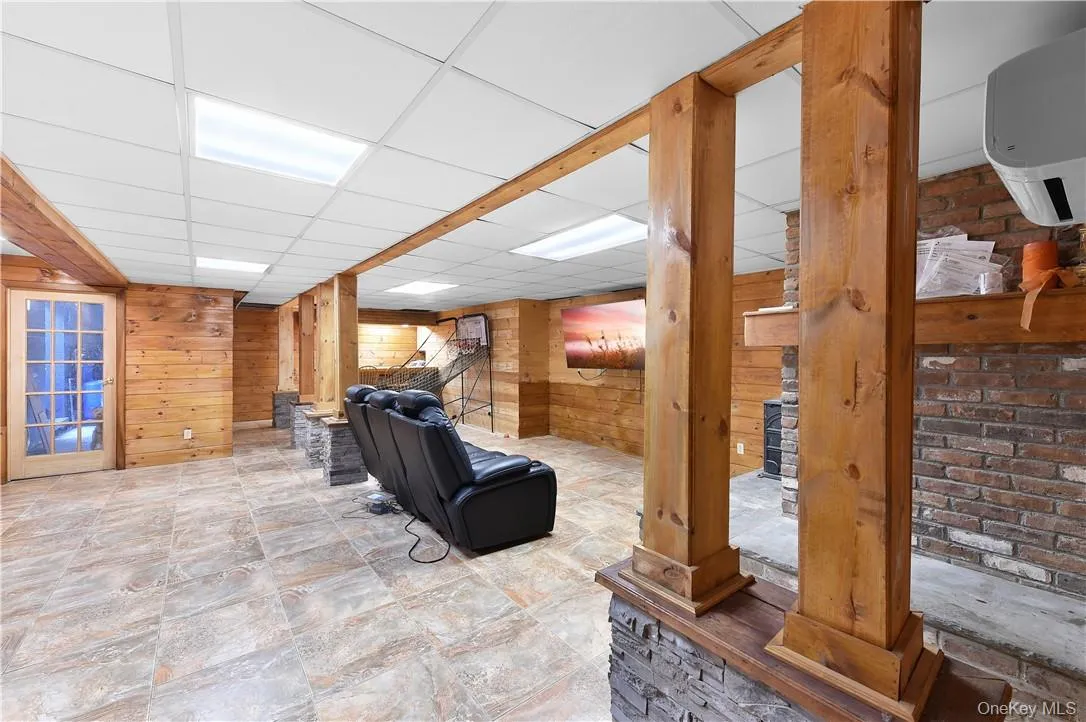 Living room with wood walls and a drop ceiling Living room with wood walls and a drop ceiling