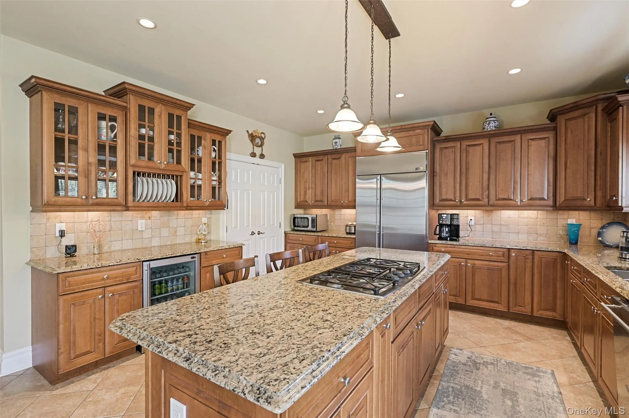 Beautiful wood cabinetry grace the spacious kitchen Beautiful wood cabinetry grace the spacious kitchen