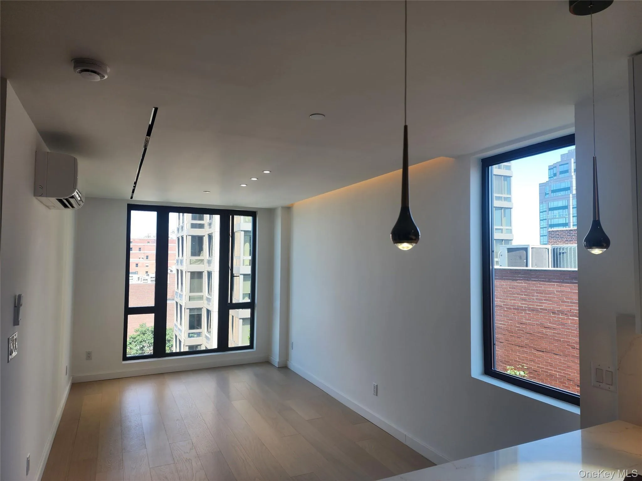 Recessed lighting, track lighting, pendant lighting, wood-finish flooring, and a built-in air conditioning unit Recessed lighting, track lighting, pendant lighting, wood-finish flooring, and a built-in air conditioning unit