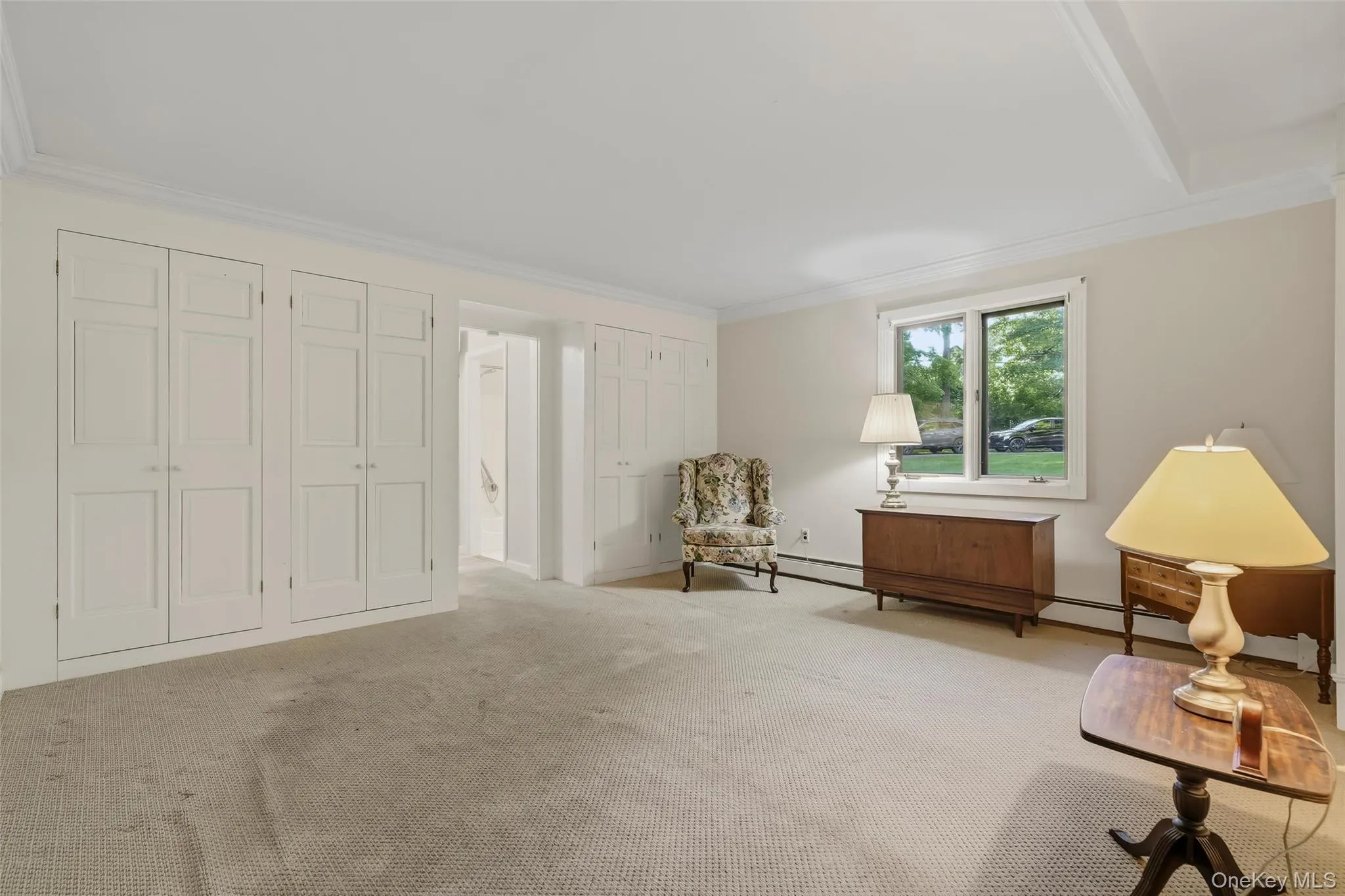 The primary bedroom offers built-in closets and a dressing area. The primary bedroom offers built-in closets and a dressing area.