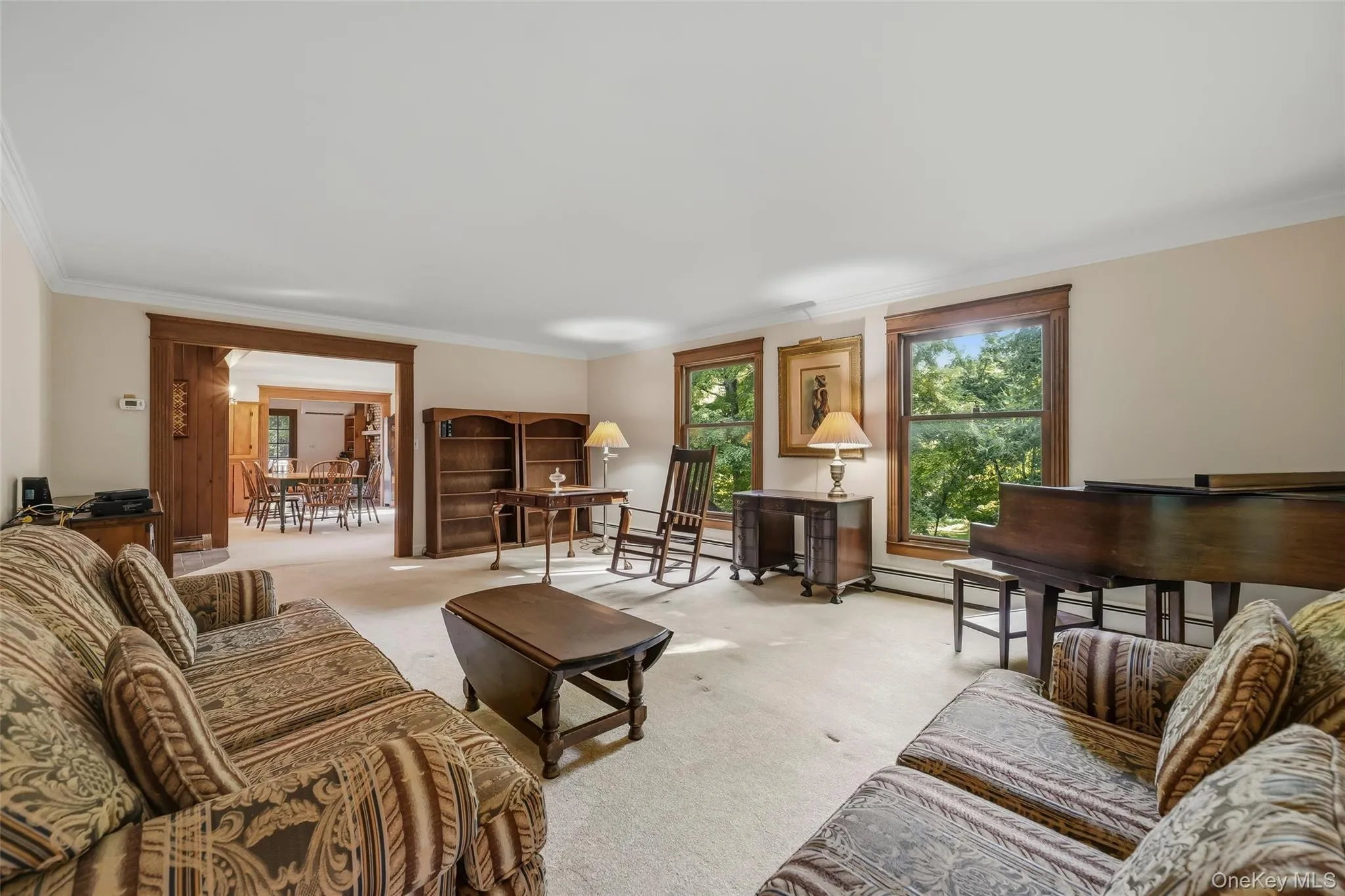 Spacious living room filled with natural light entering from the large windows. Spacious living room filled with natural light entering from the large windows.