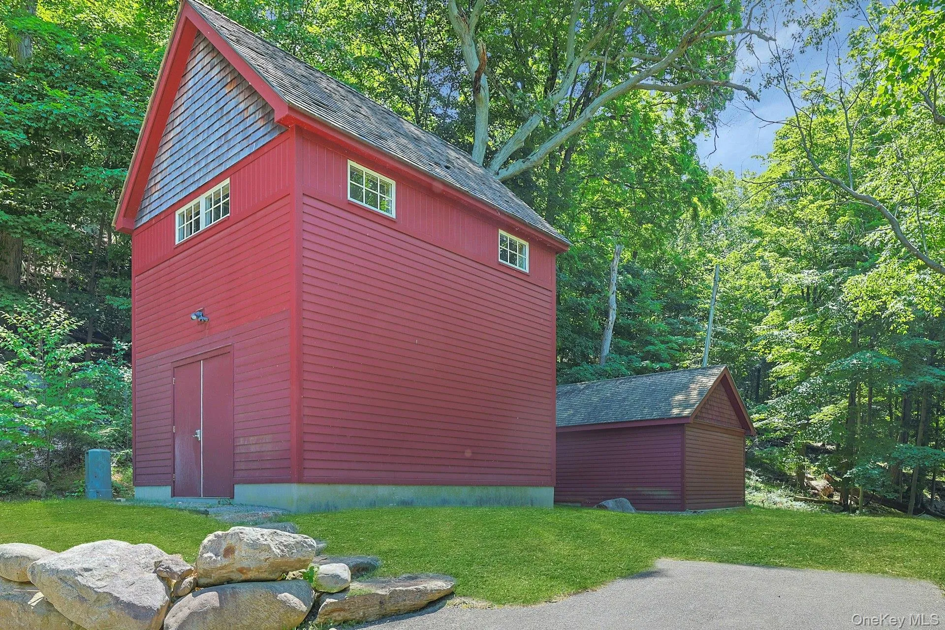 This is a view of the large shed and the water tower building, which holds an eighteen foot high tower that contains all of the water this home could need. The tower, like every mechanical aspect of this home, has been rigorously designed and built to exceed the highest standard. Between the two buildings is a propane fueled backup generator. This is a view of the large shed and the water tower building, which holds an eighteen foot high tower that contains all of the water this home could need. The tower, like every mechanical aspect of this home, has been rigorously designed and built to exceed the highest standard. Between the two buildings is a propane fueled backup generator.